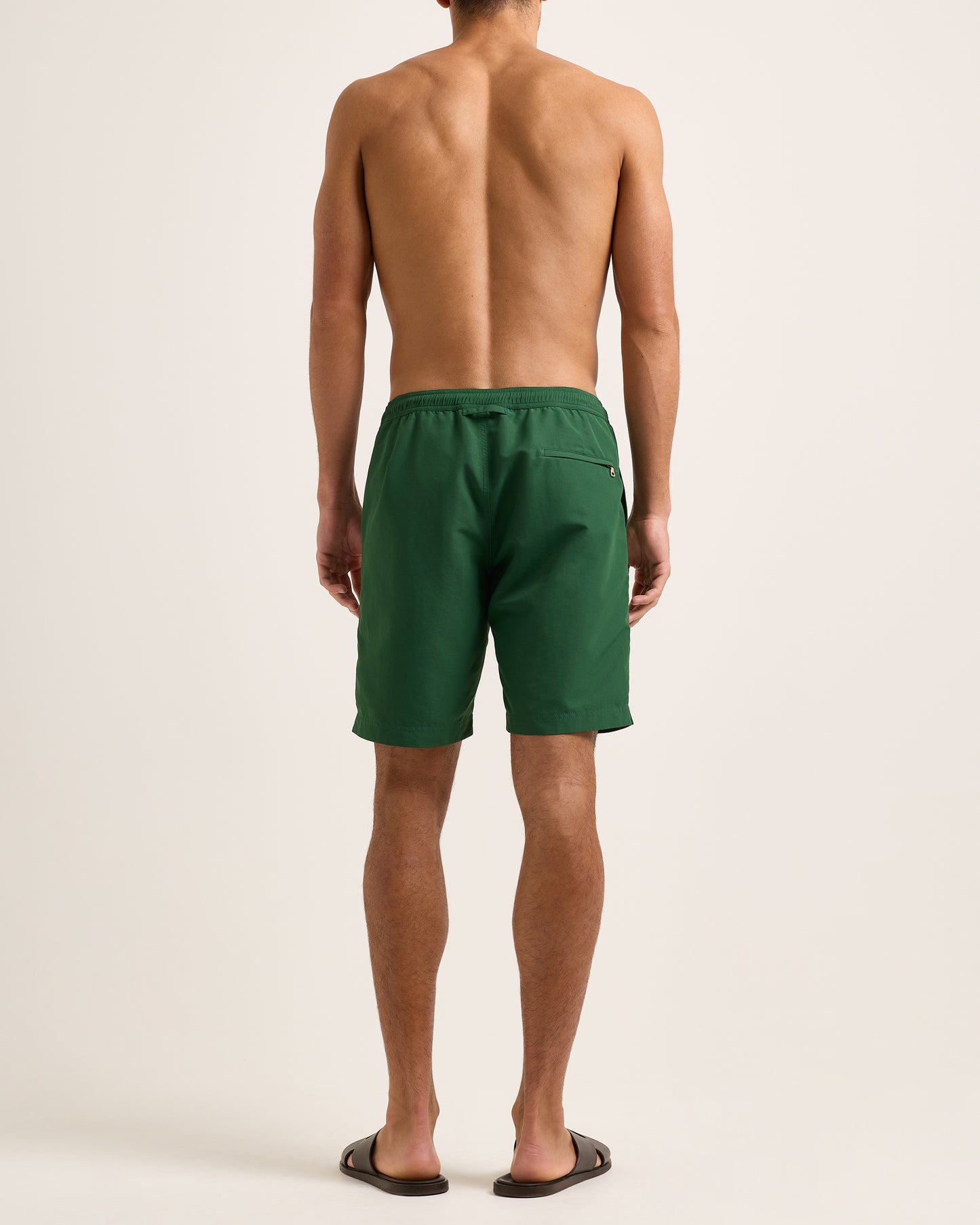 Man wearing green shorts with a drawstring on a white background