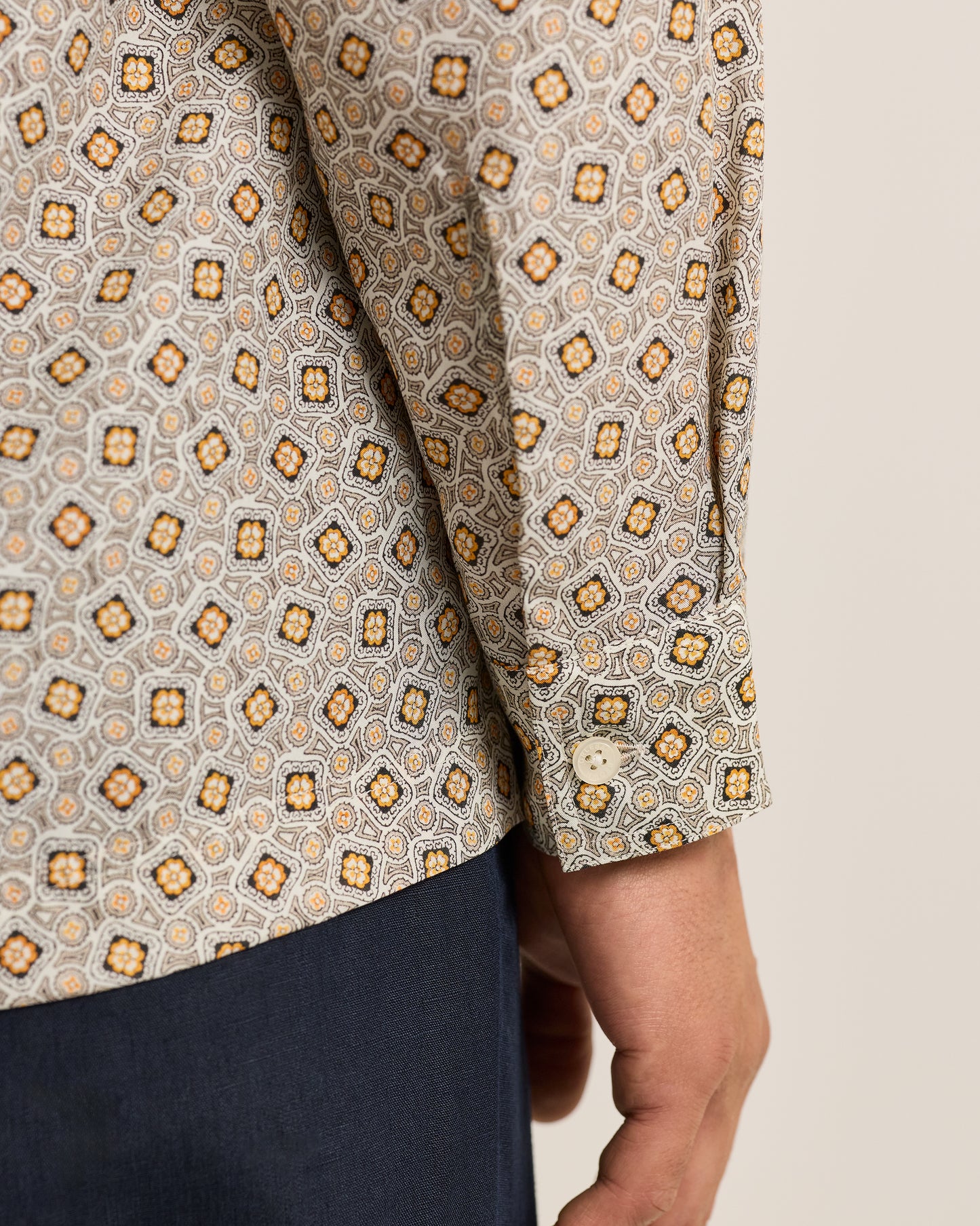 Close-up of a patterned shirt with geometric design on a neutral background
