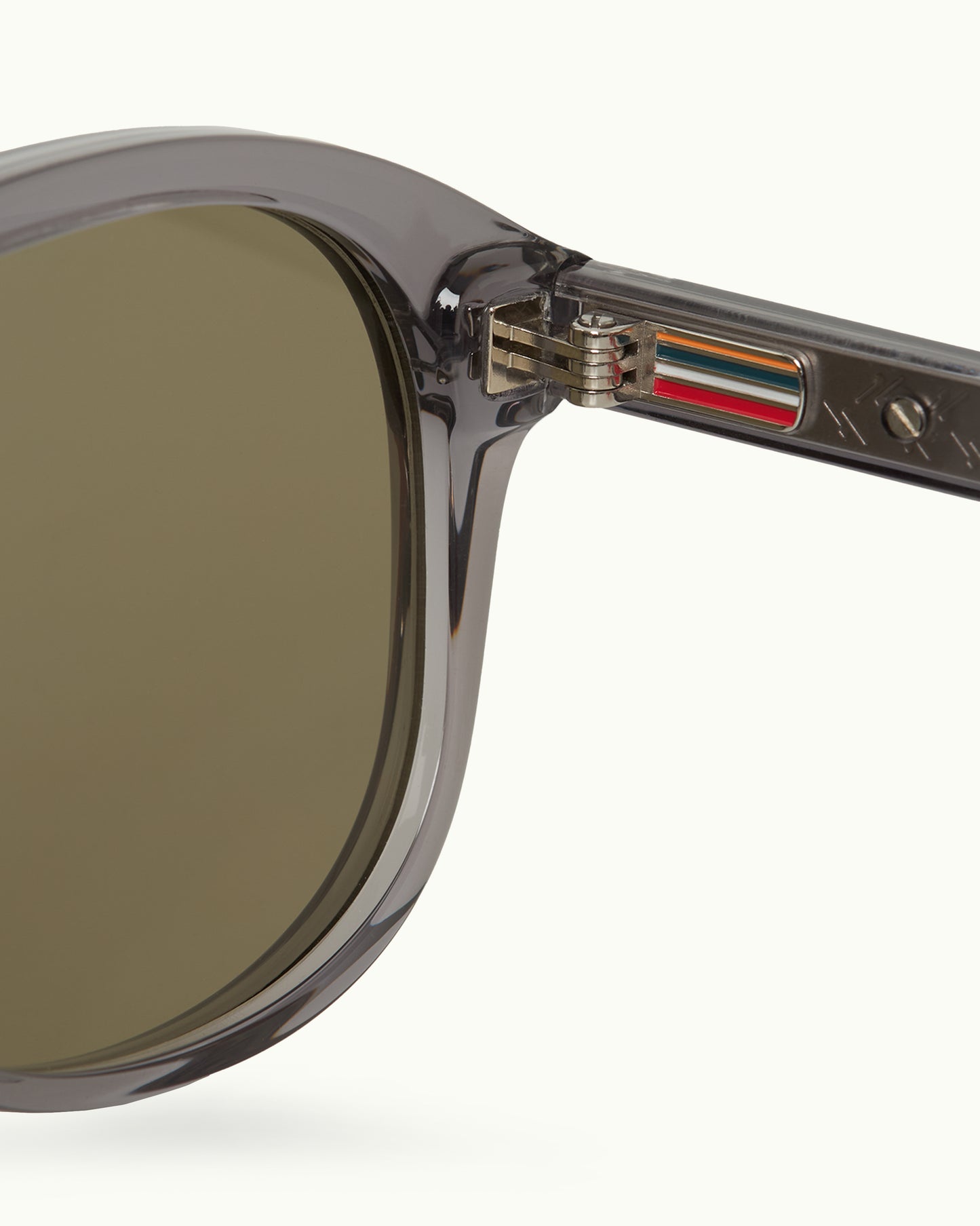 Sunglasses with a brand logo on the frame against a white background