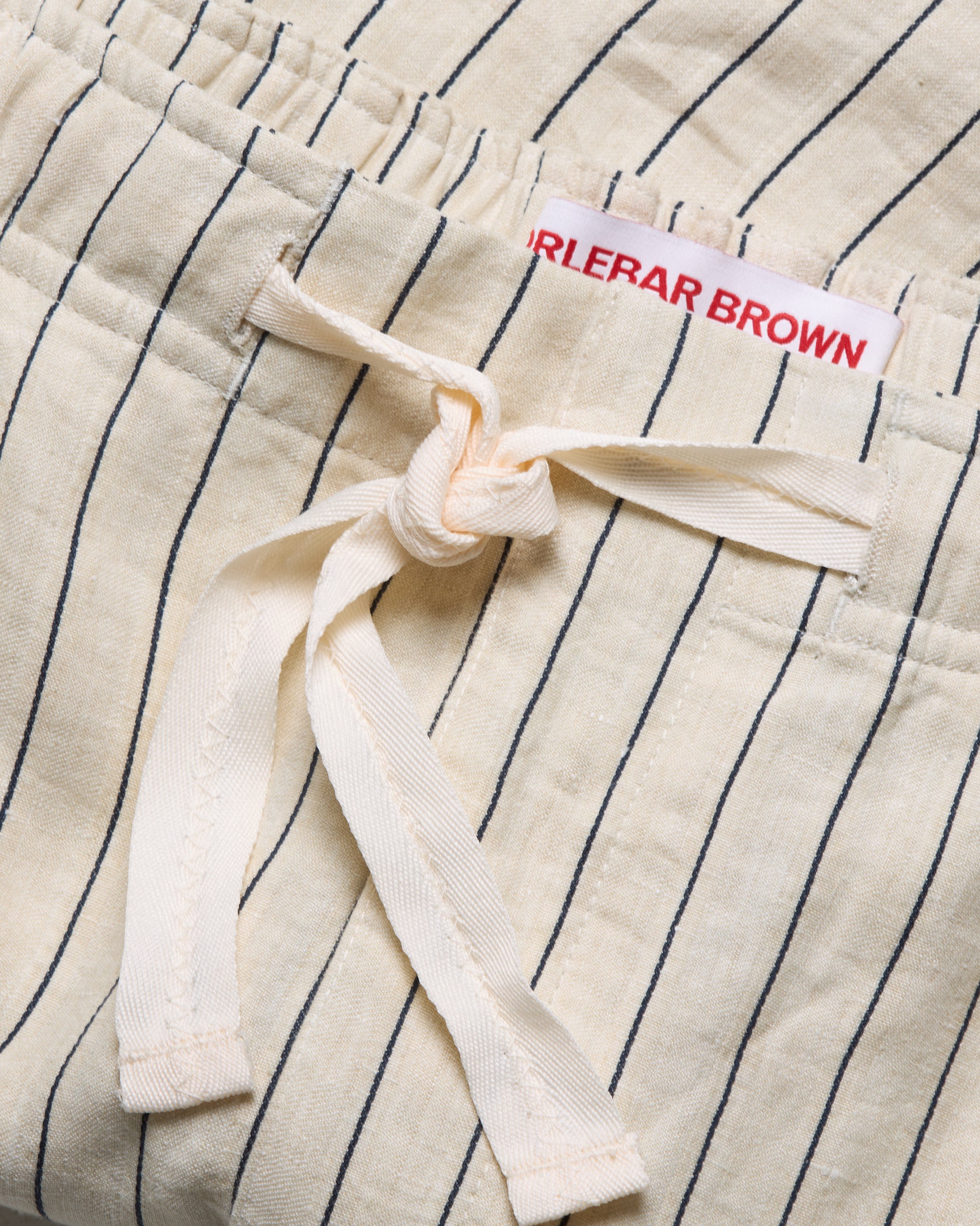 Close-up of a striped garment with a brand label on a white background