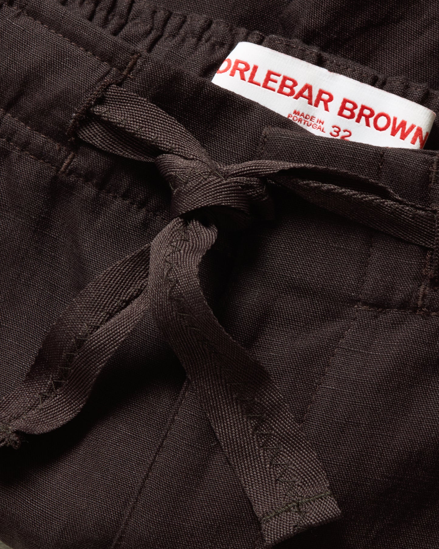 Close-up of a black garment with a Orlebar Brown label.