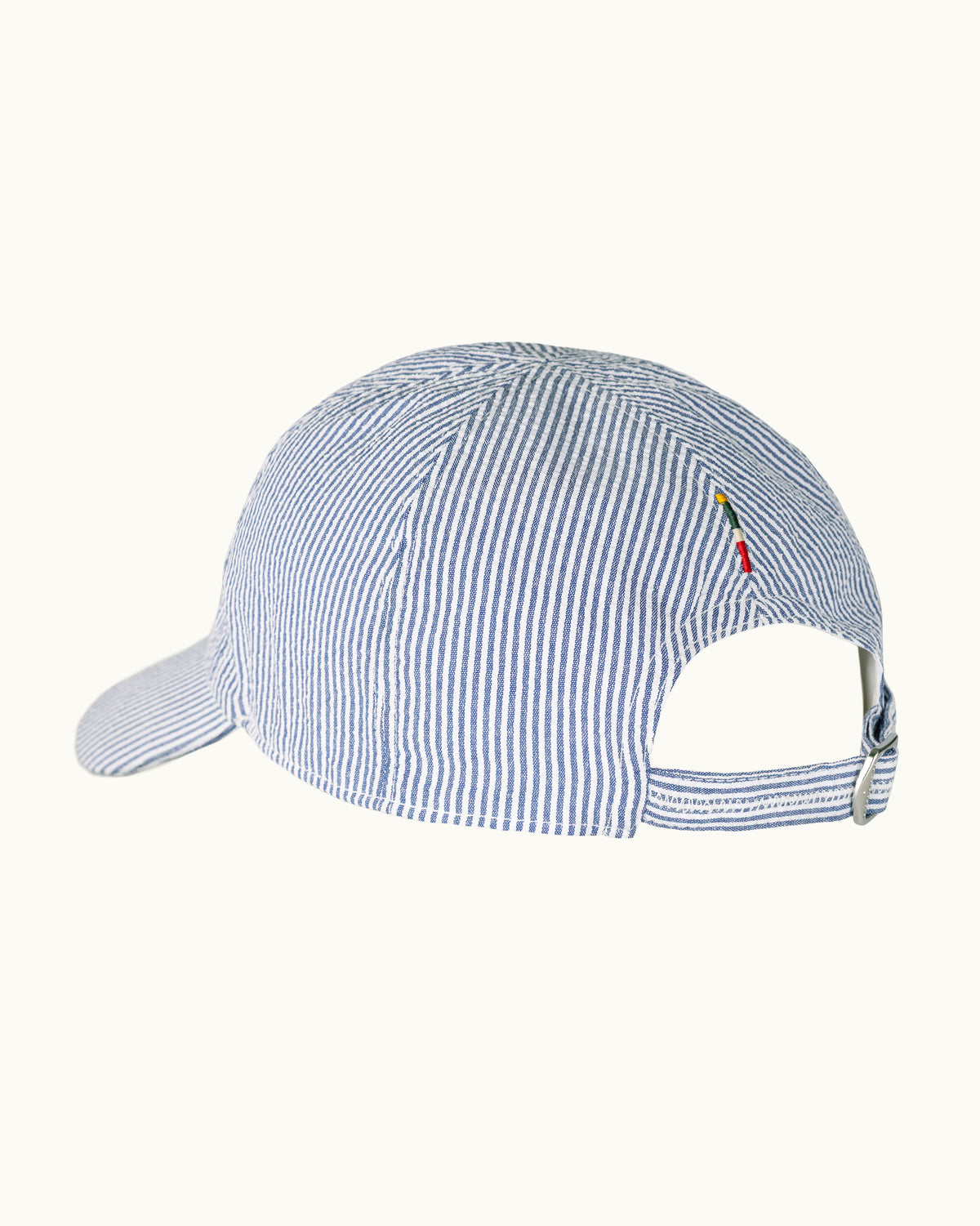 A blue and white vertically striped baseball cap shown from a side-rear angle on a plain off-white background.