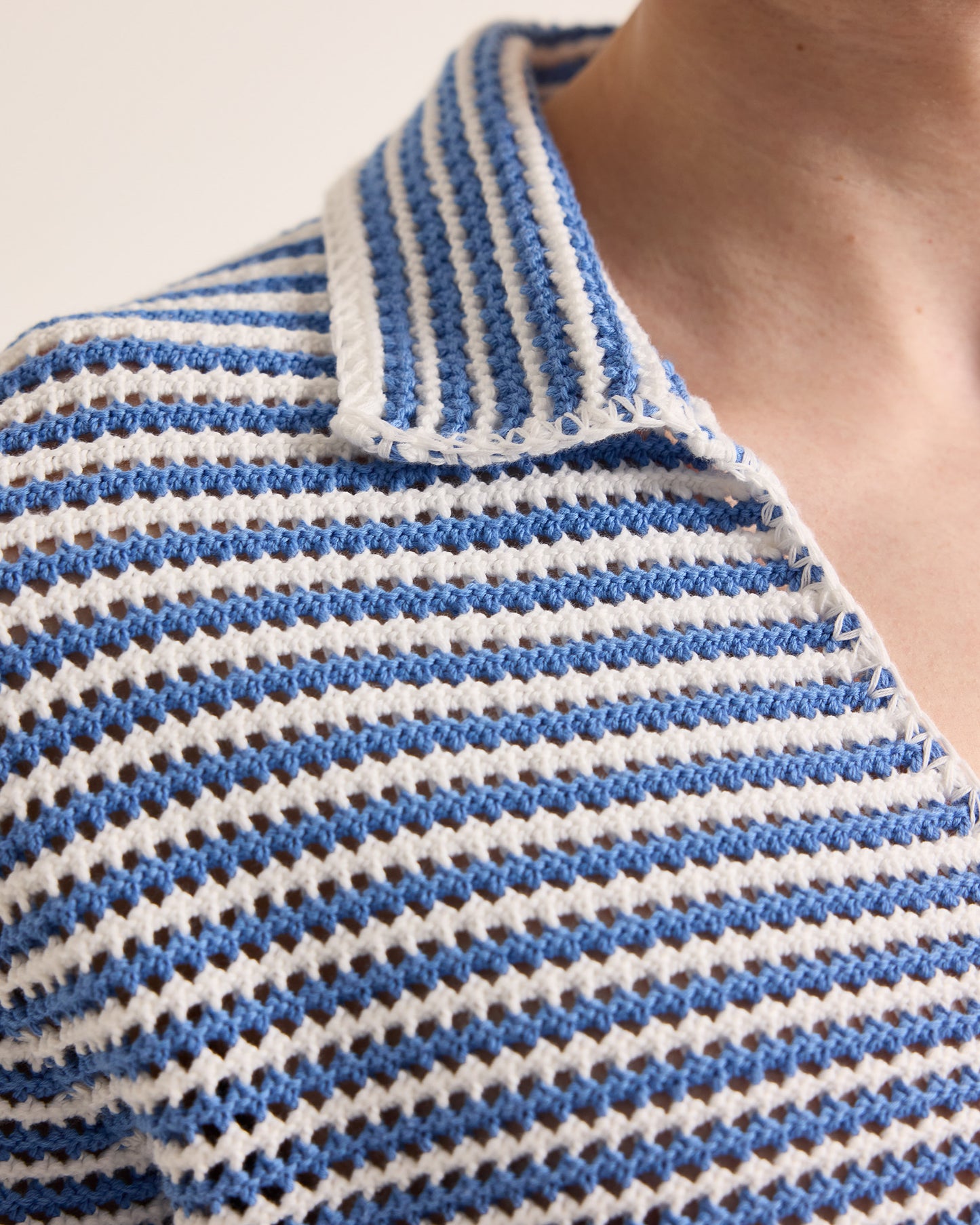 Close-up of a blue and white striped knit garment.