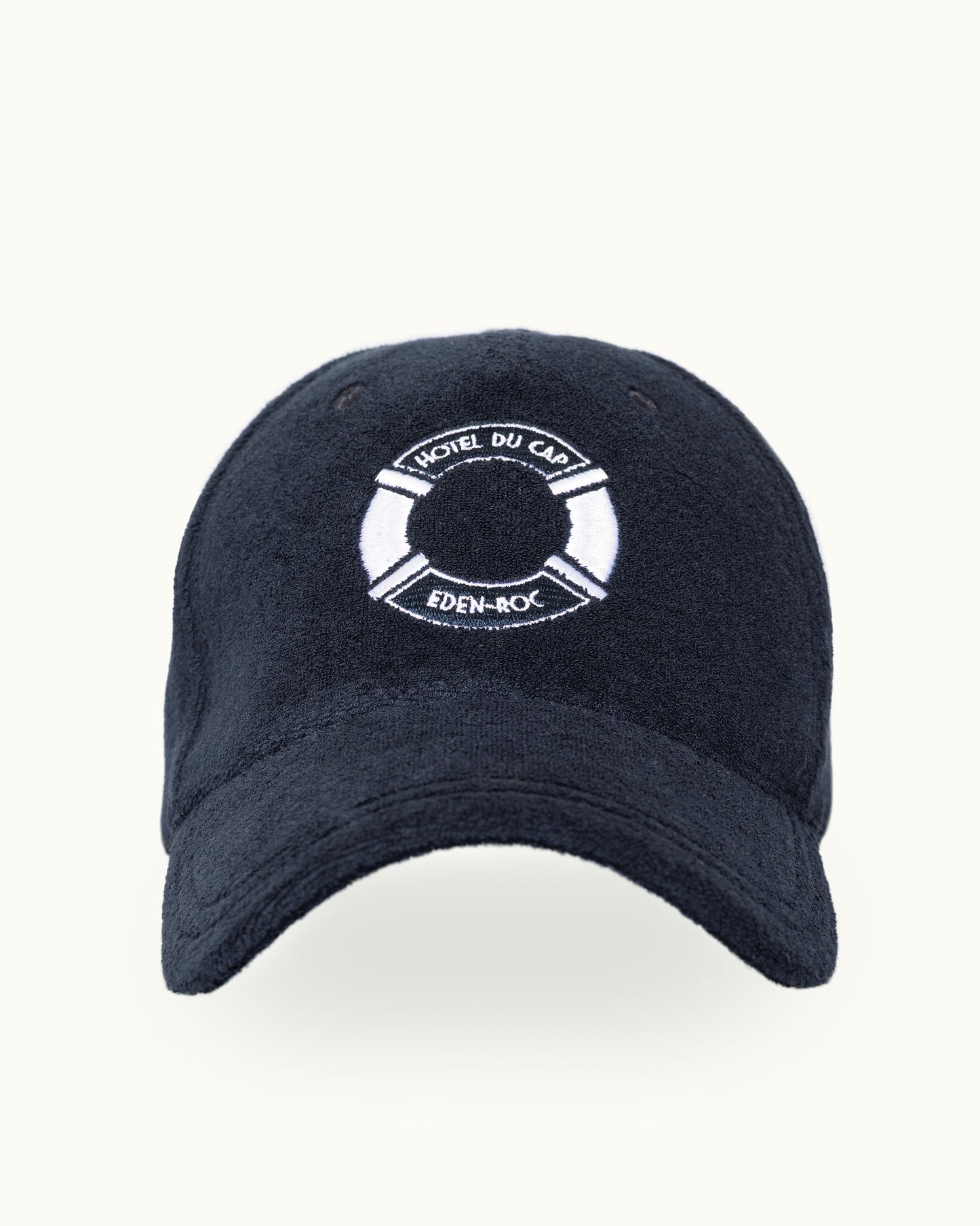 A dark navy blue baseball cap with a white embroidered life preserver logo on the front. The logo contains the text 'Hotel DU CAP' and 'EDEN-ROCK'.