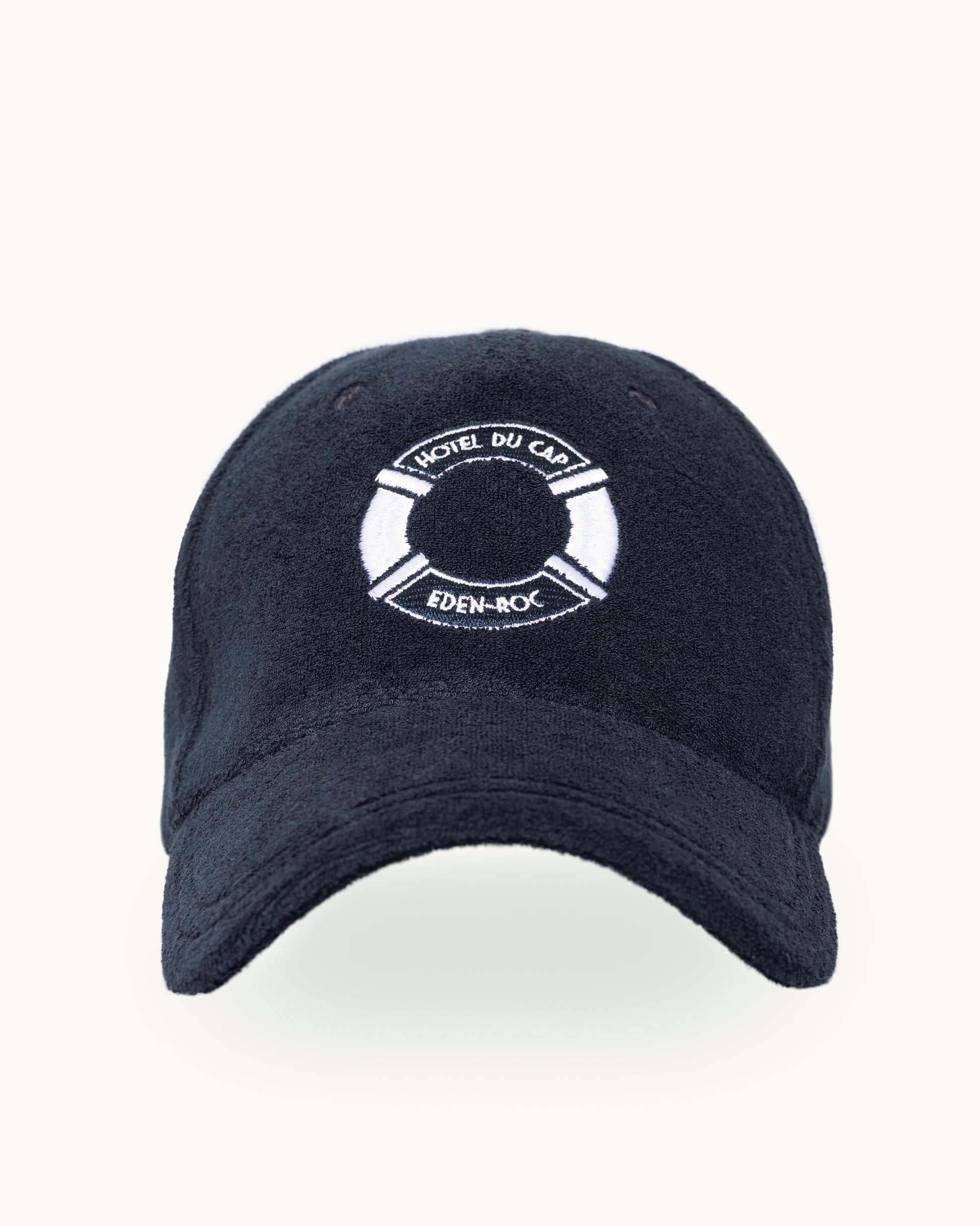 A dark navy blue baseball cap with a white embroidered life preserver logo on the front. The logo contains the text 'Hotel DU CAP' and 'EDEN-ROCK'.
