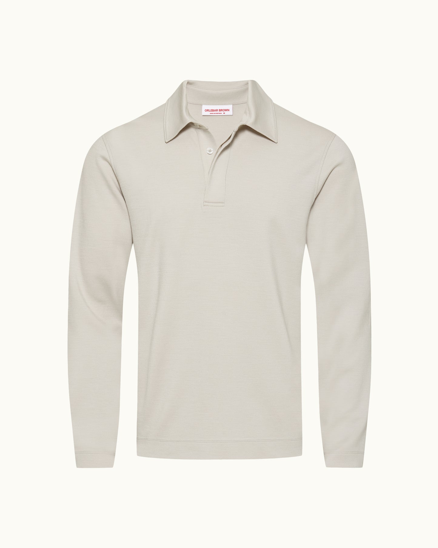A light beige long-sleeve polo shirt with a collar and two-button placket, shown on a clean off-white background.