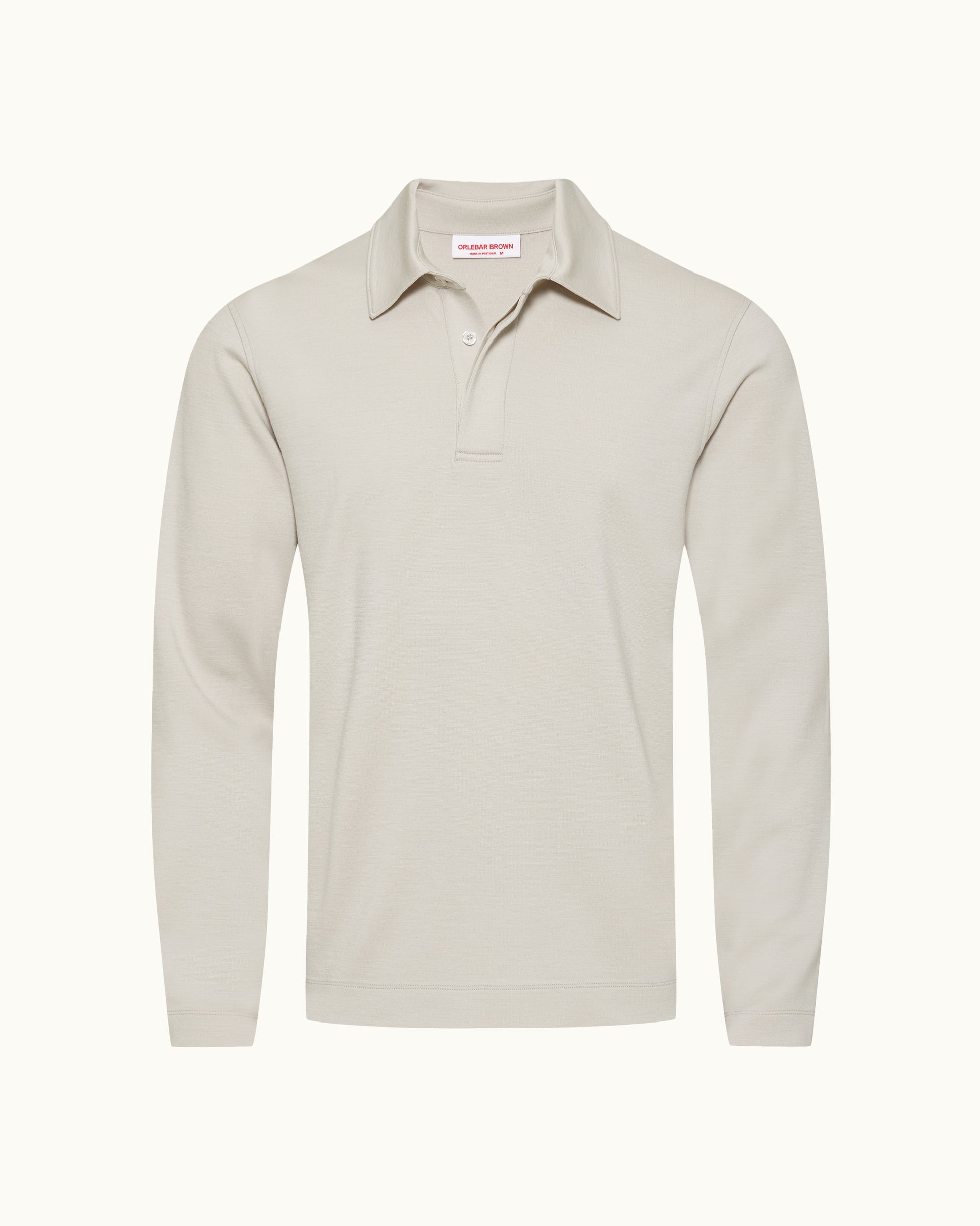 A light beige long-sleeve polo shirt with a collar and two-button placket, shown on a clean off-white background.