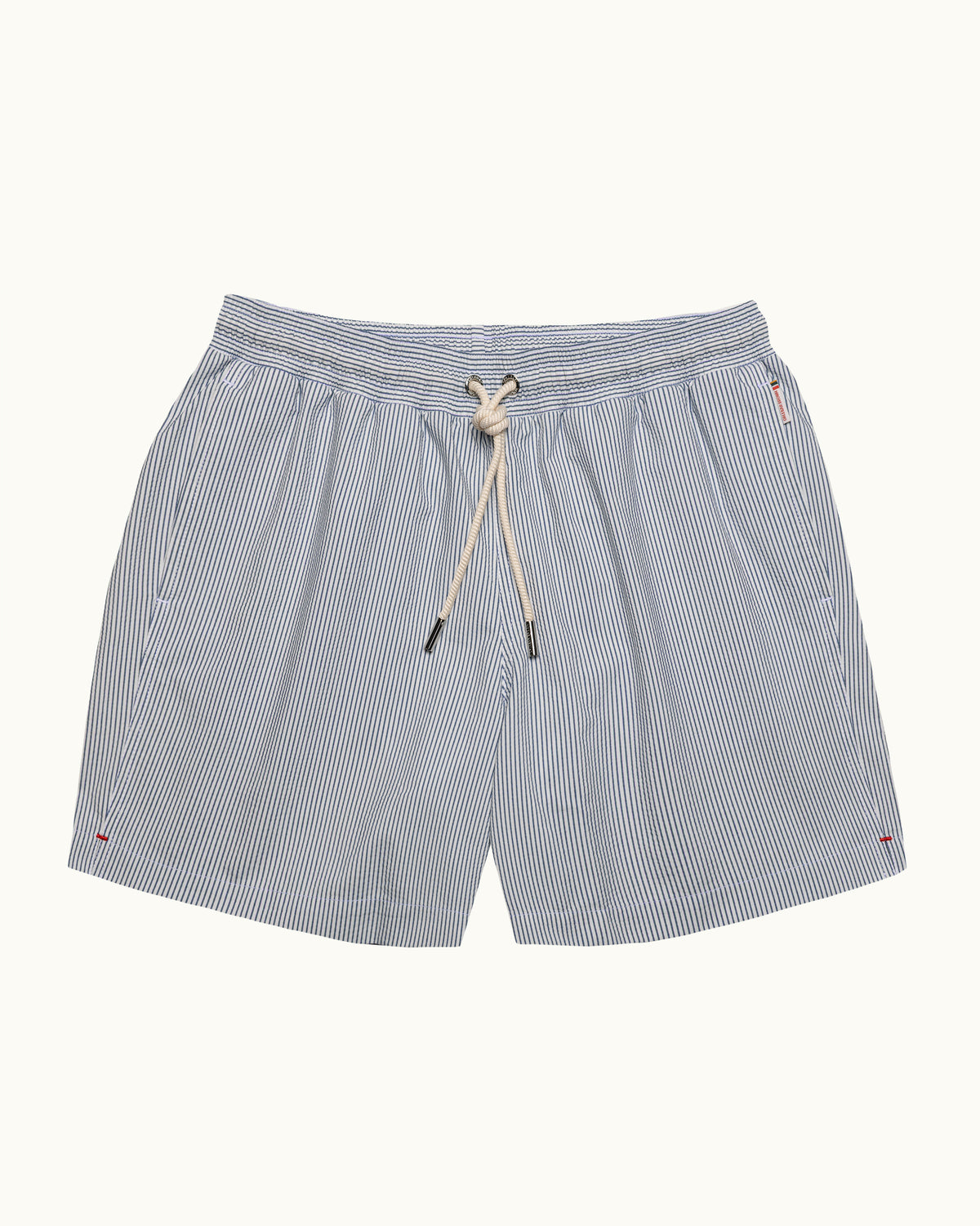 Light blue and white pinstriped swim shorts with an elastic drawstring waist, displayed flat against a light off-white background.
