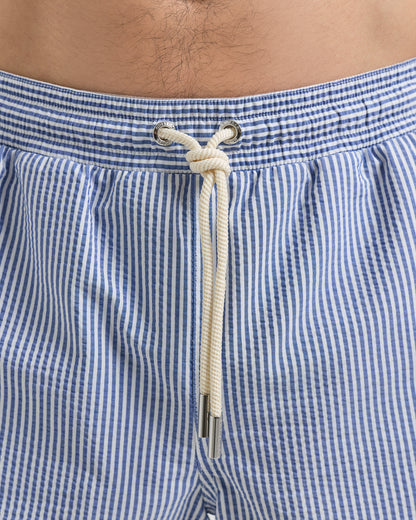 Close-up of blue and white checkered swim shorts with a rope tie.
