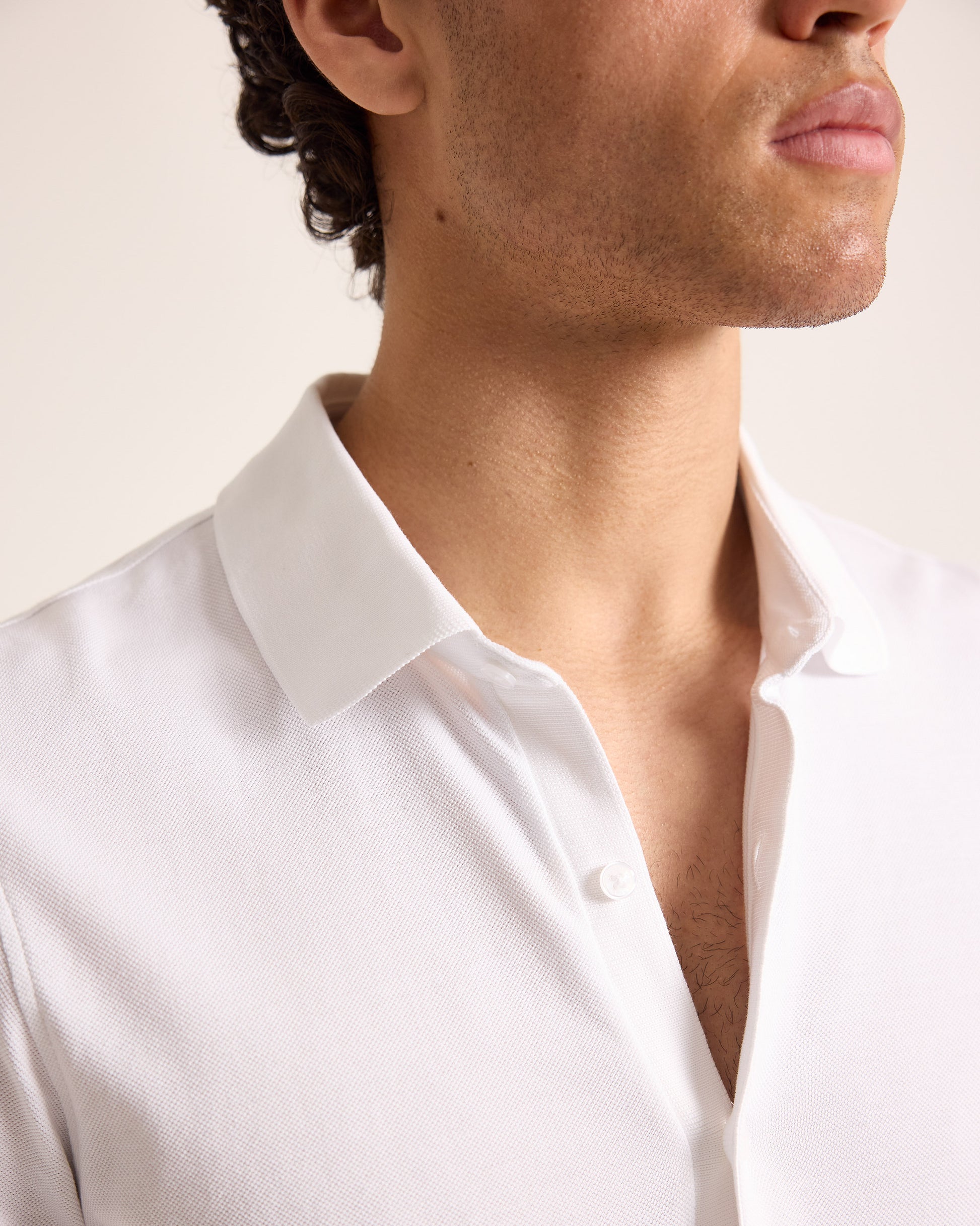Closeup of a white polo shirt collar detailing 