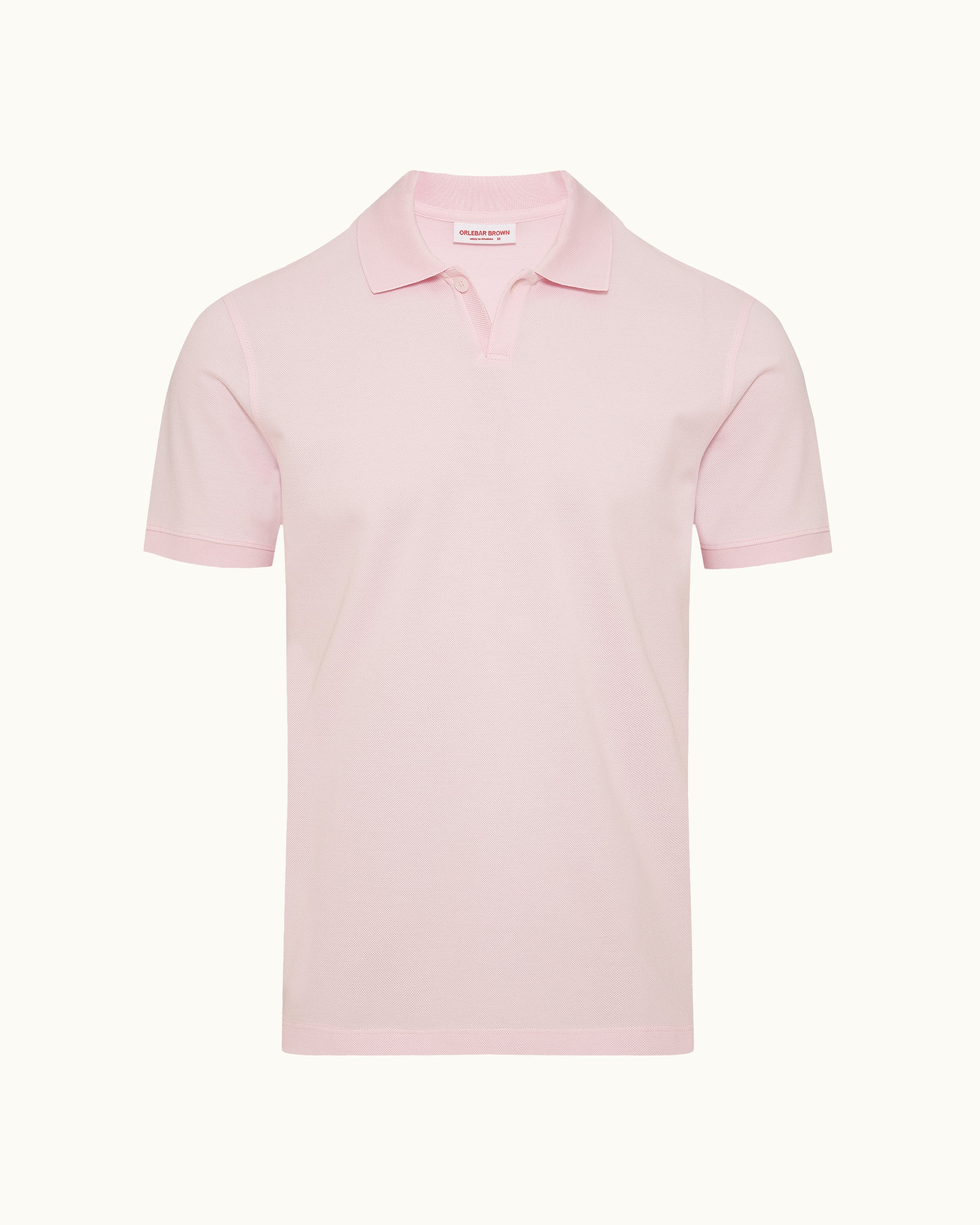 Pink polo shirt on a plain background