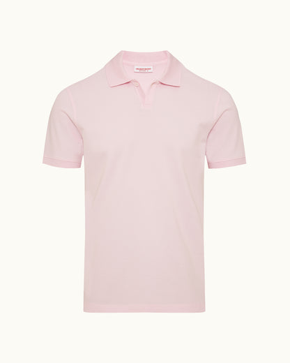 Pink polo shirt on a plain background