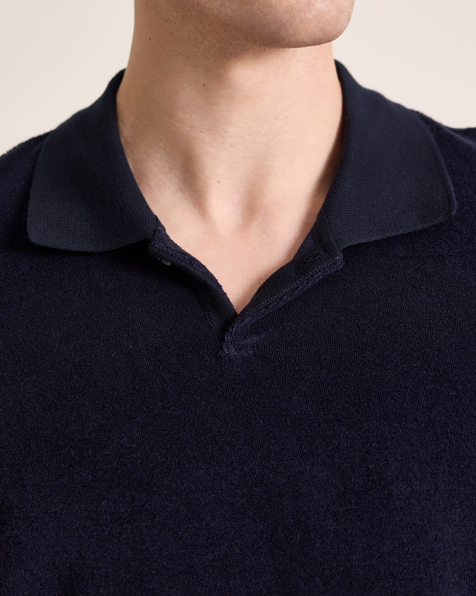 Navy blue polo shirt collar on a neutral background