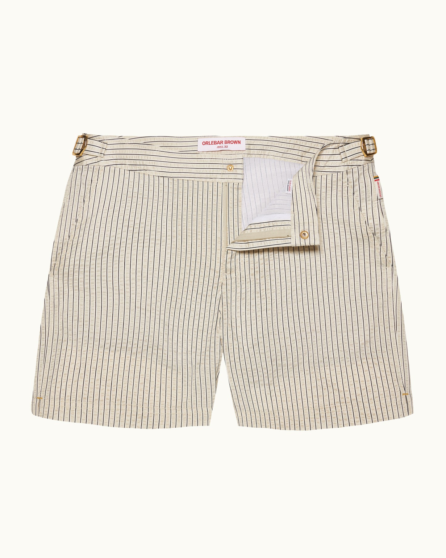 Beige stripey swim shorts on a plain background