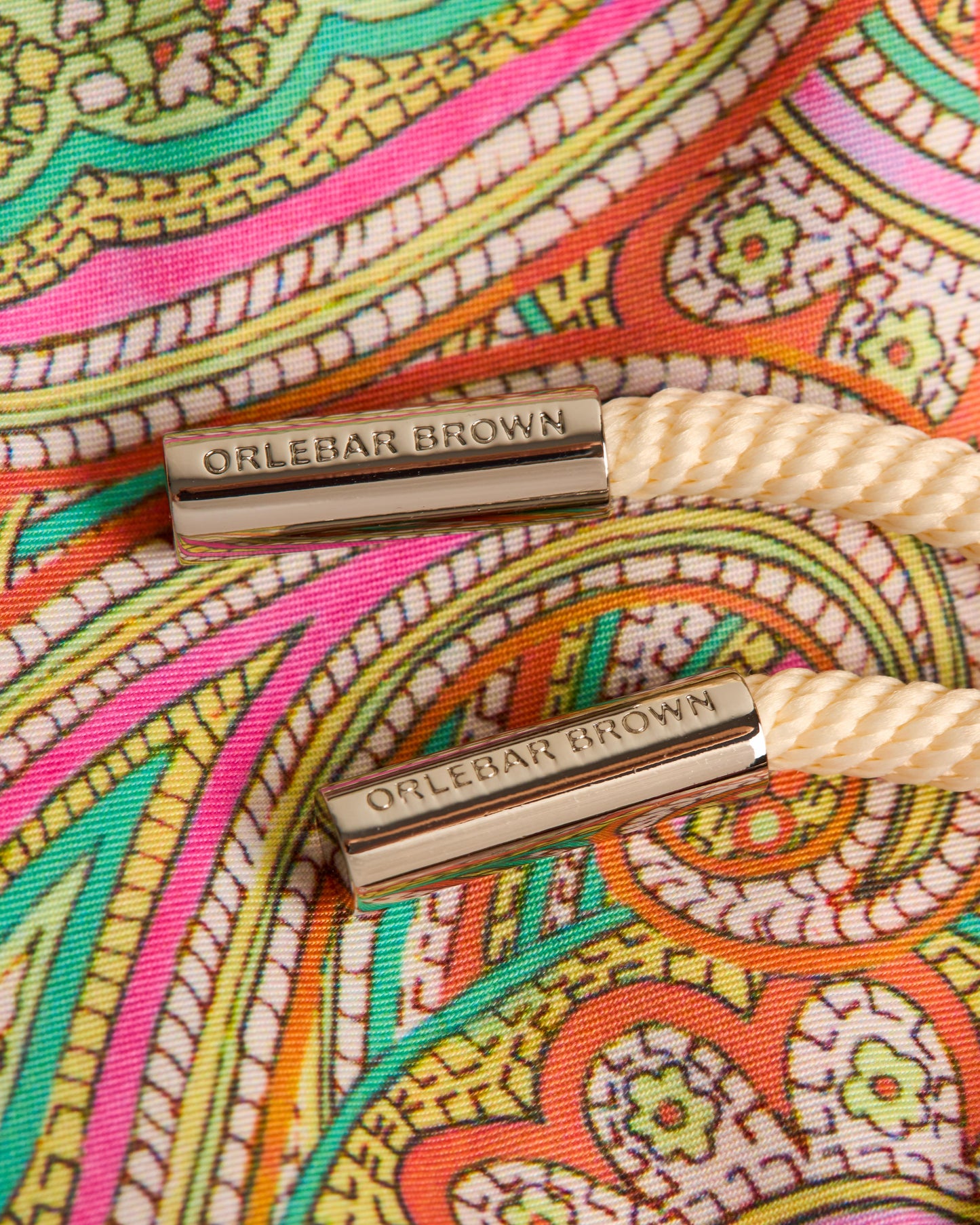 Colorful patterned fabric with 'Orlebar Brown' branding on a strap.