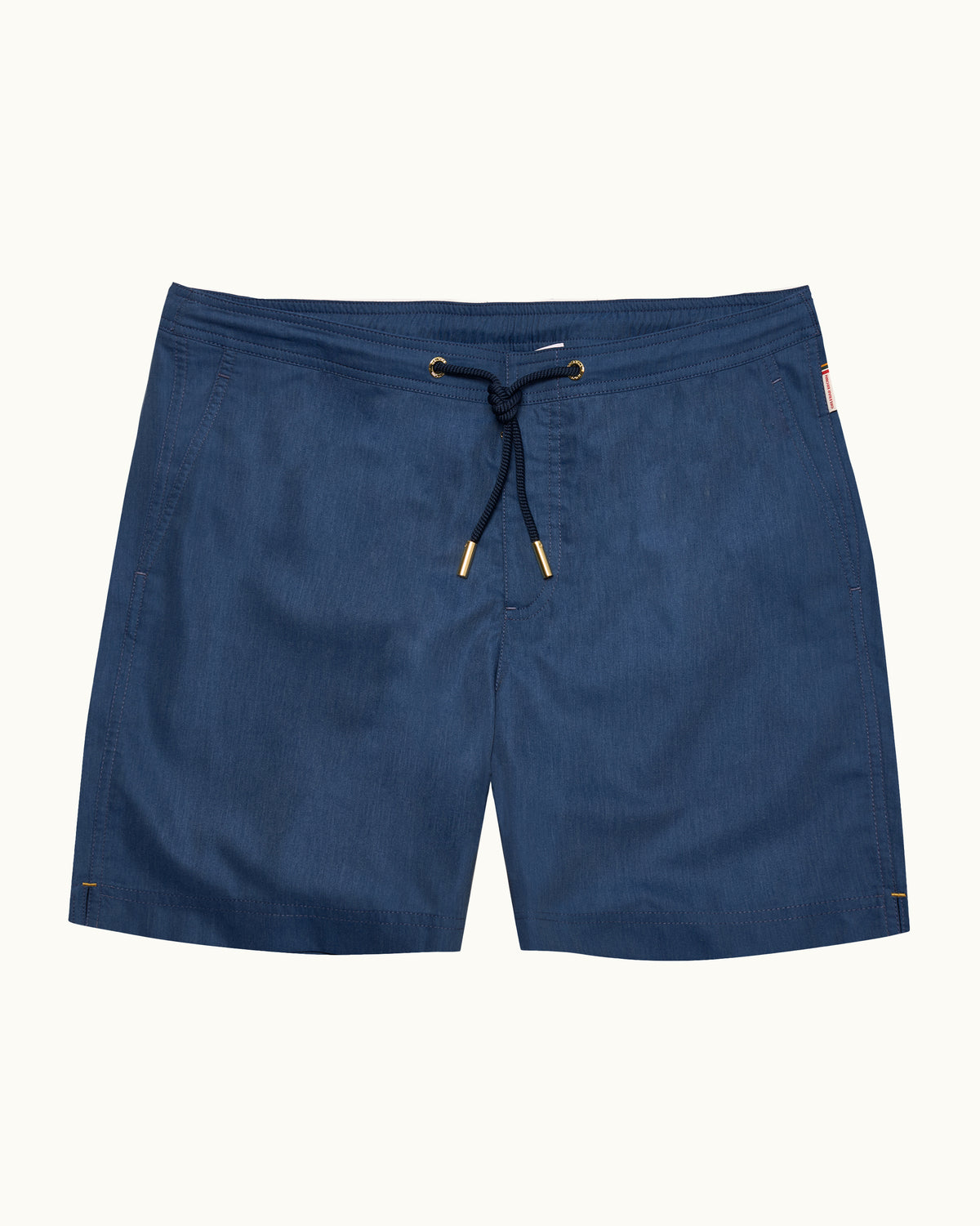 Denim blue drawcord swim shorts with a navy robe on a plain background
