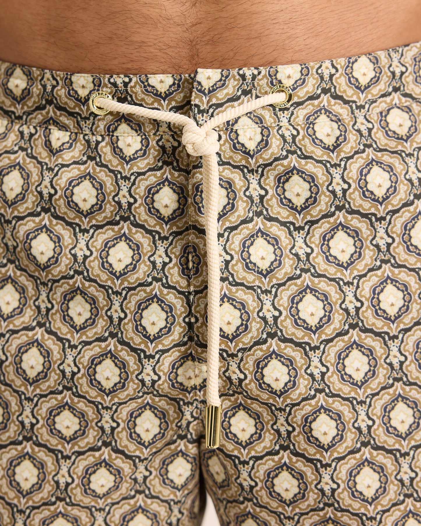 Closeup of geometric print swim shorts with drawstring waist