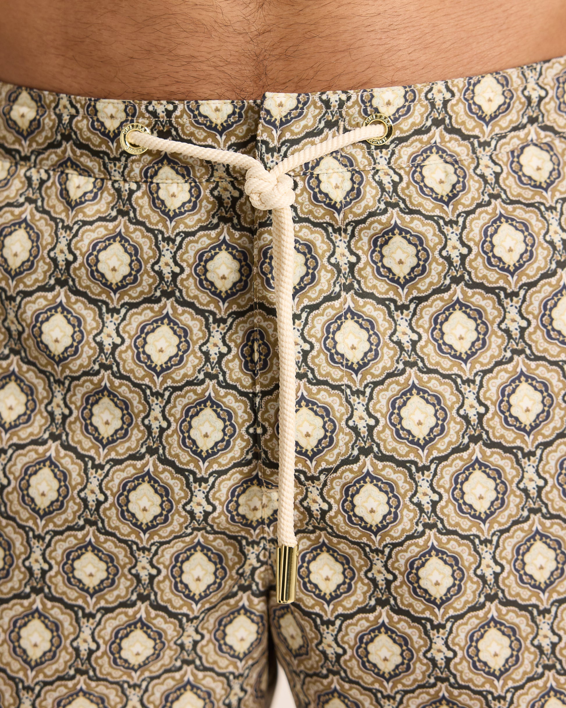 Closeup of geometric print swim shorts with drawstring waist