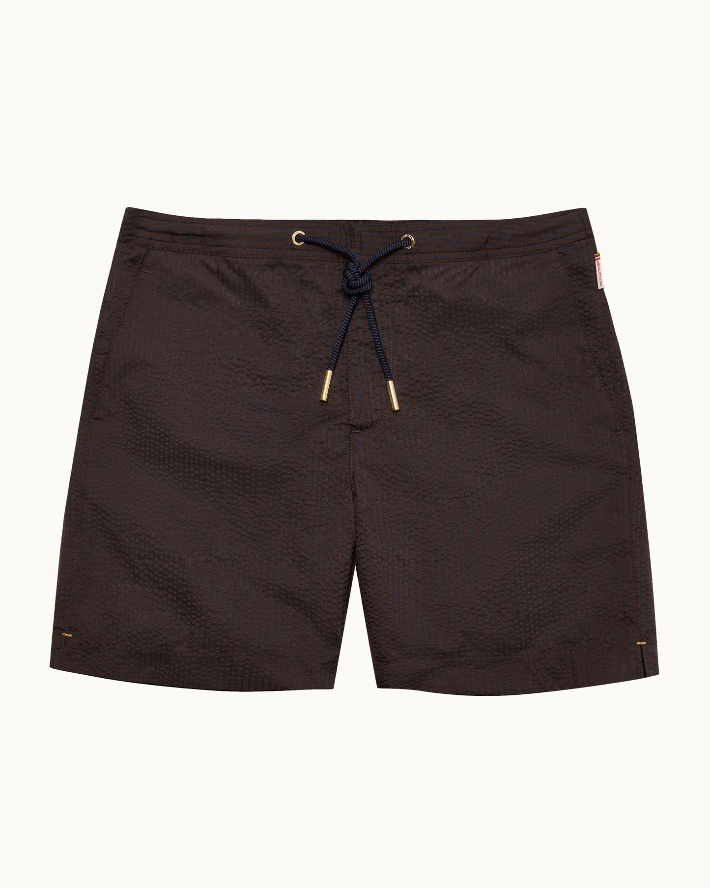 Dark brown textured swim trunks with a navy blue drawstring and gold-toned metal tips, displayed flat against a light off-white background.