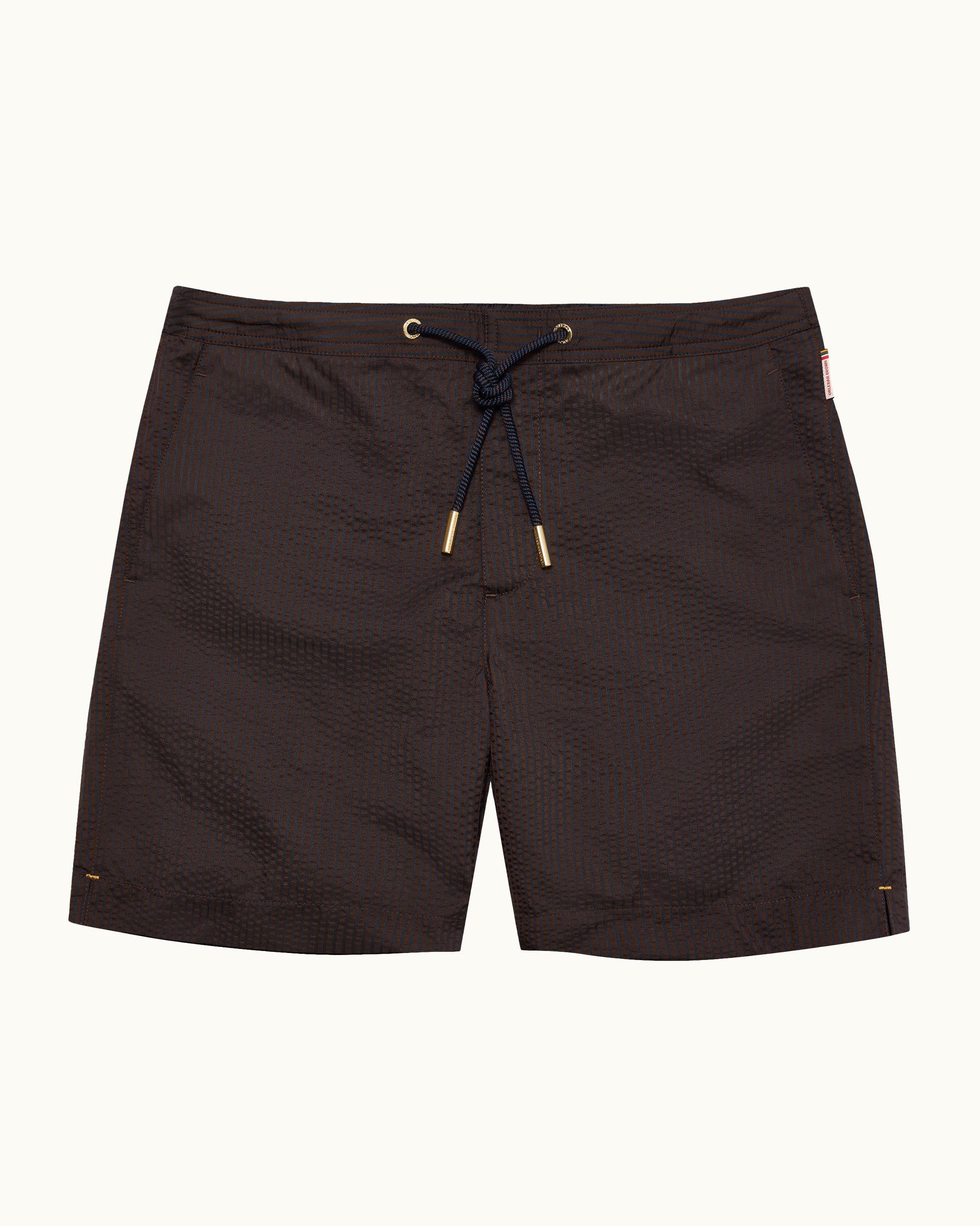 Dark brown textured swim trunks with a navy blue drawstring and gold-toned metal tips, displayed flat against a light off-white background.