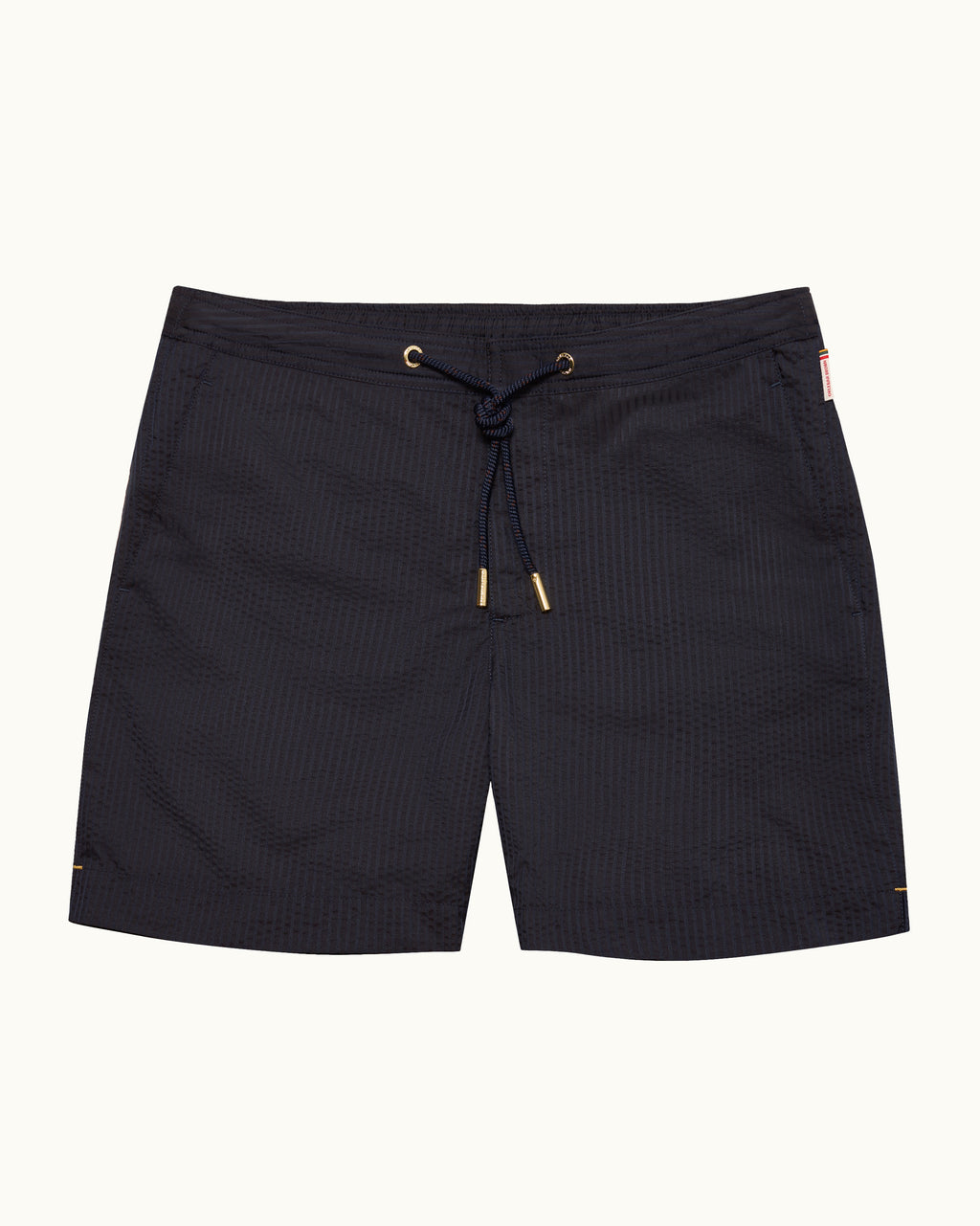 Black textured drawstring board shorts with gold-tone eyelets and tips, shown flat against a light off-white background.