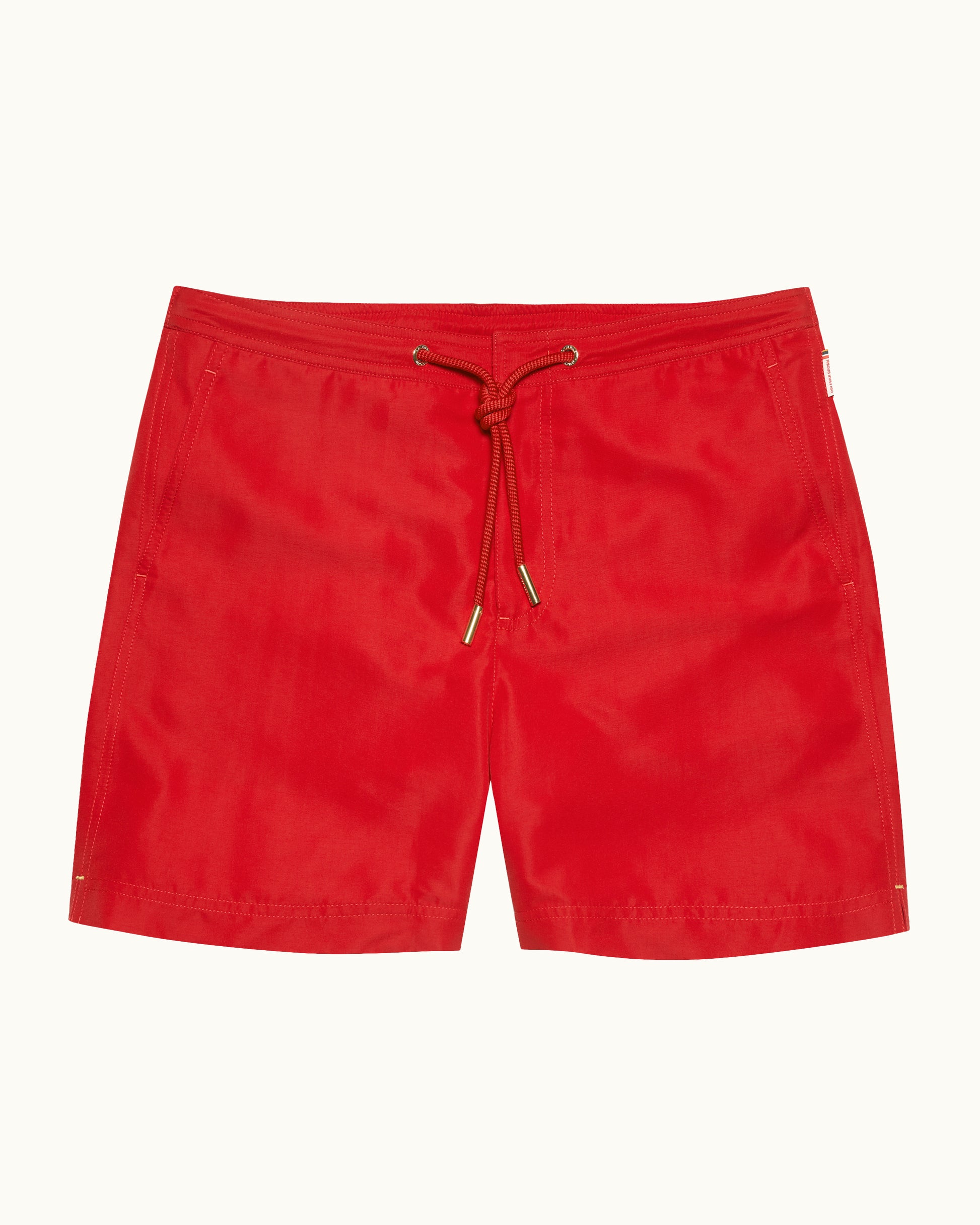 Red shorts with a drawstring on a white background
