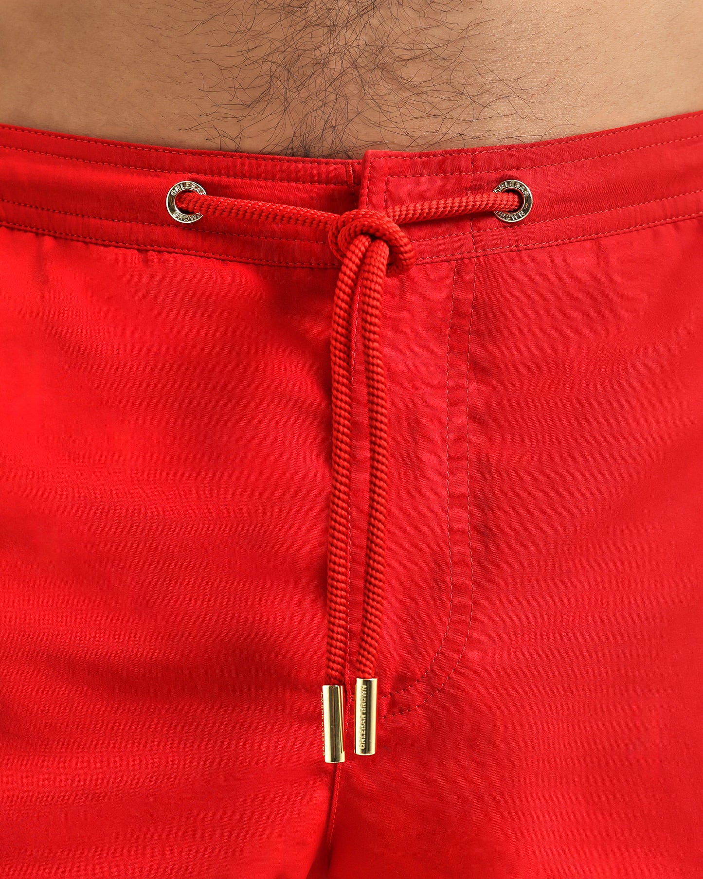 closeup of red swim short with drawcord detail