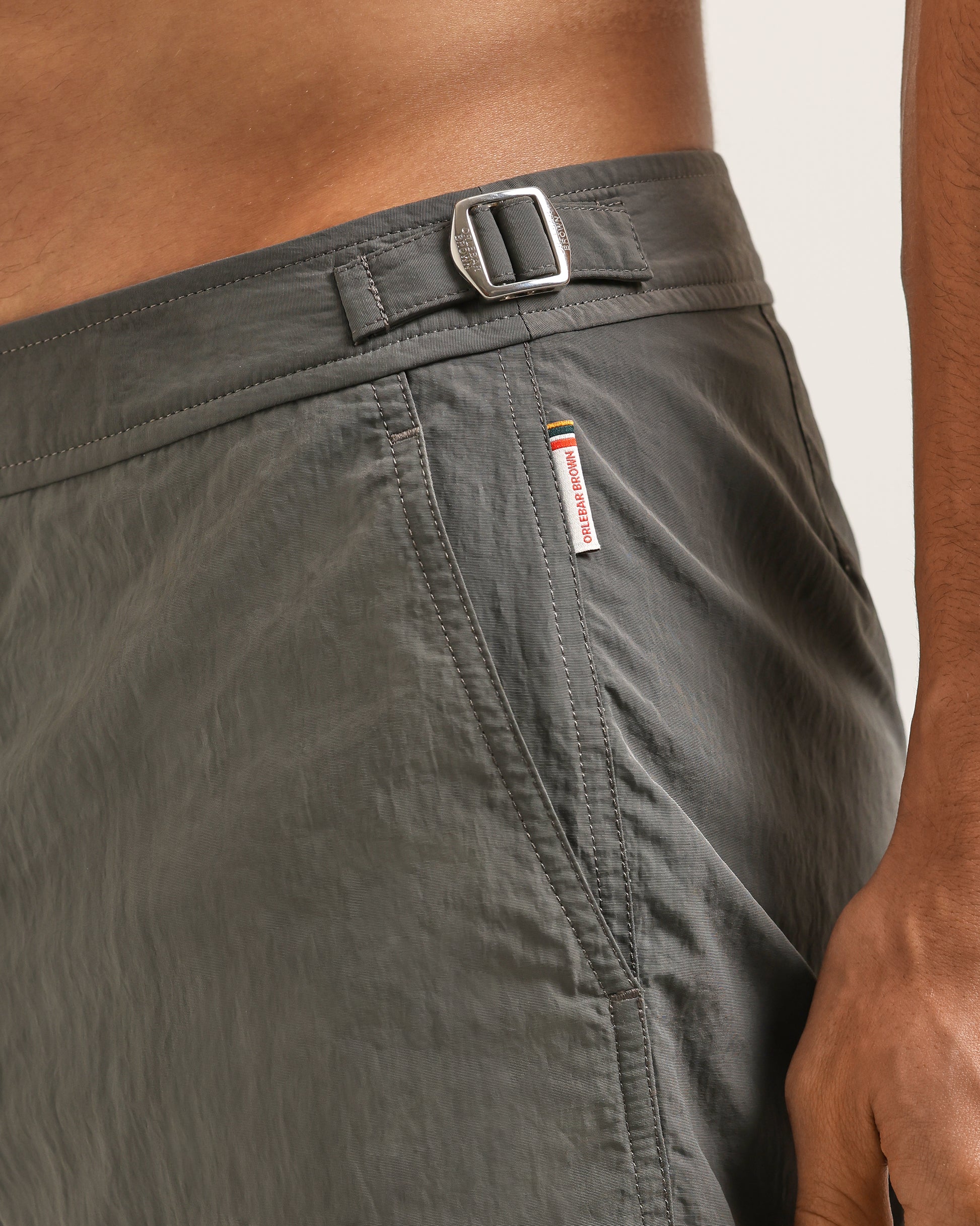 Gray shorts with a visible brand logo on a neutral background