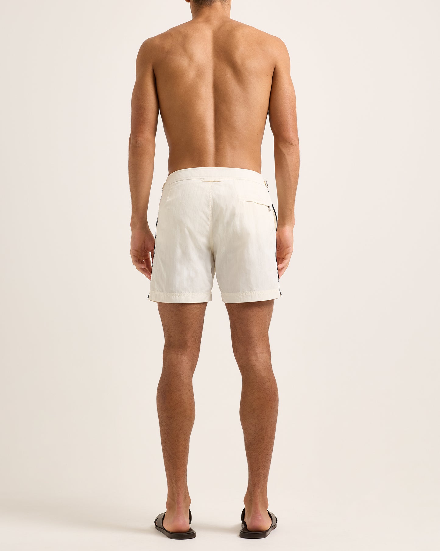 Man wearing white shorts on a plain background