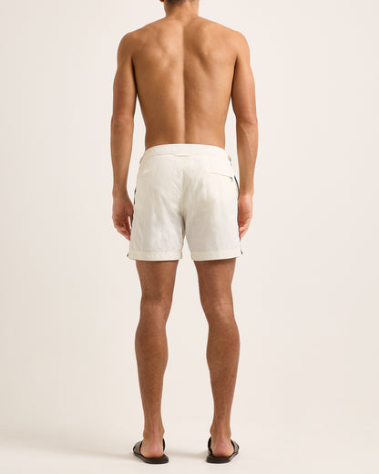 Man wearing white shorts on a plain background