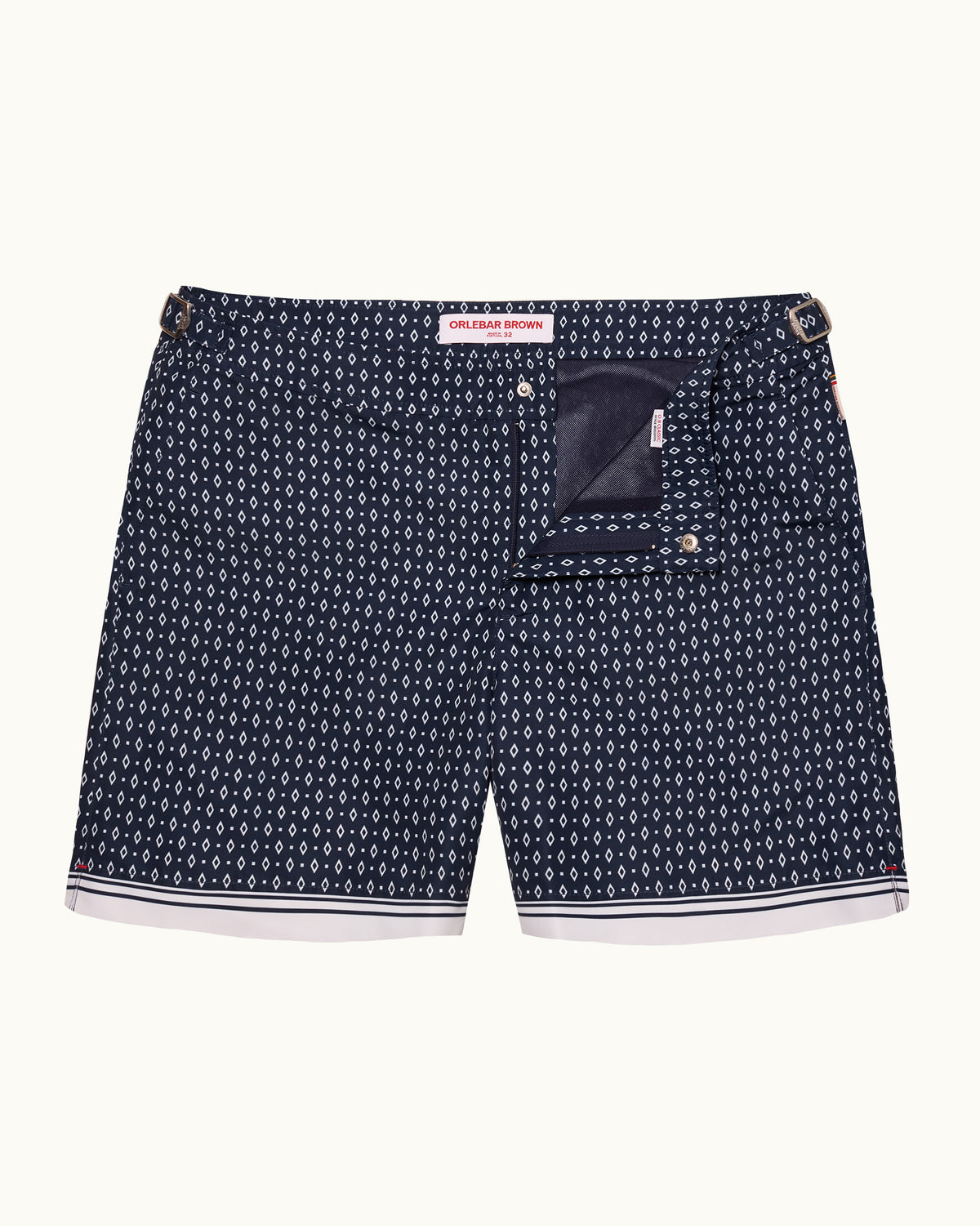 A pair of men's shorts, featuring a navy blue and white pattern print, a back pocket with a dark navy lining, and a white hem with navy stripes.