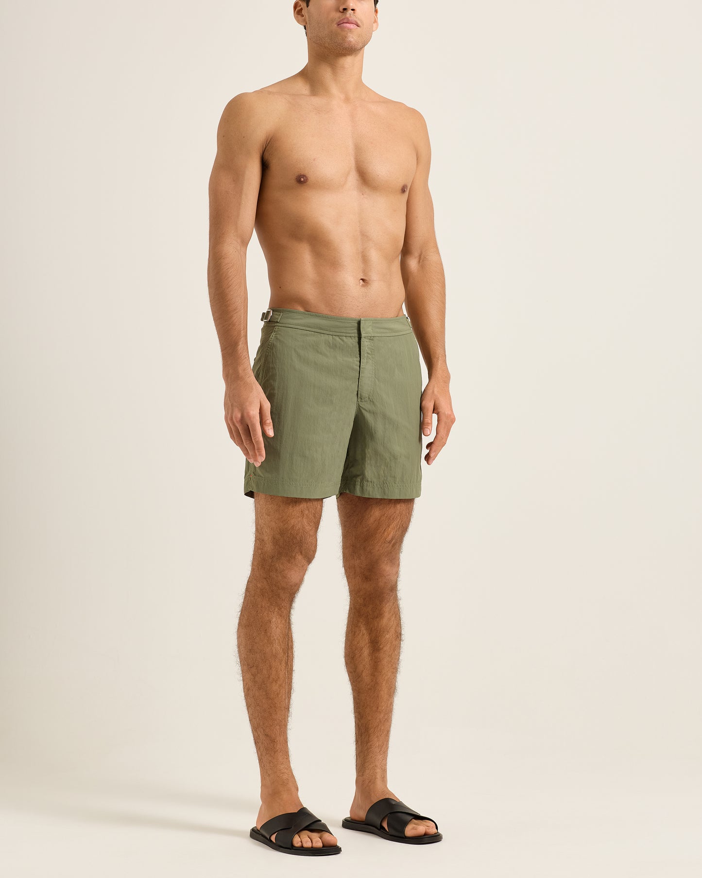 Man wearing green shorts on a plain background