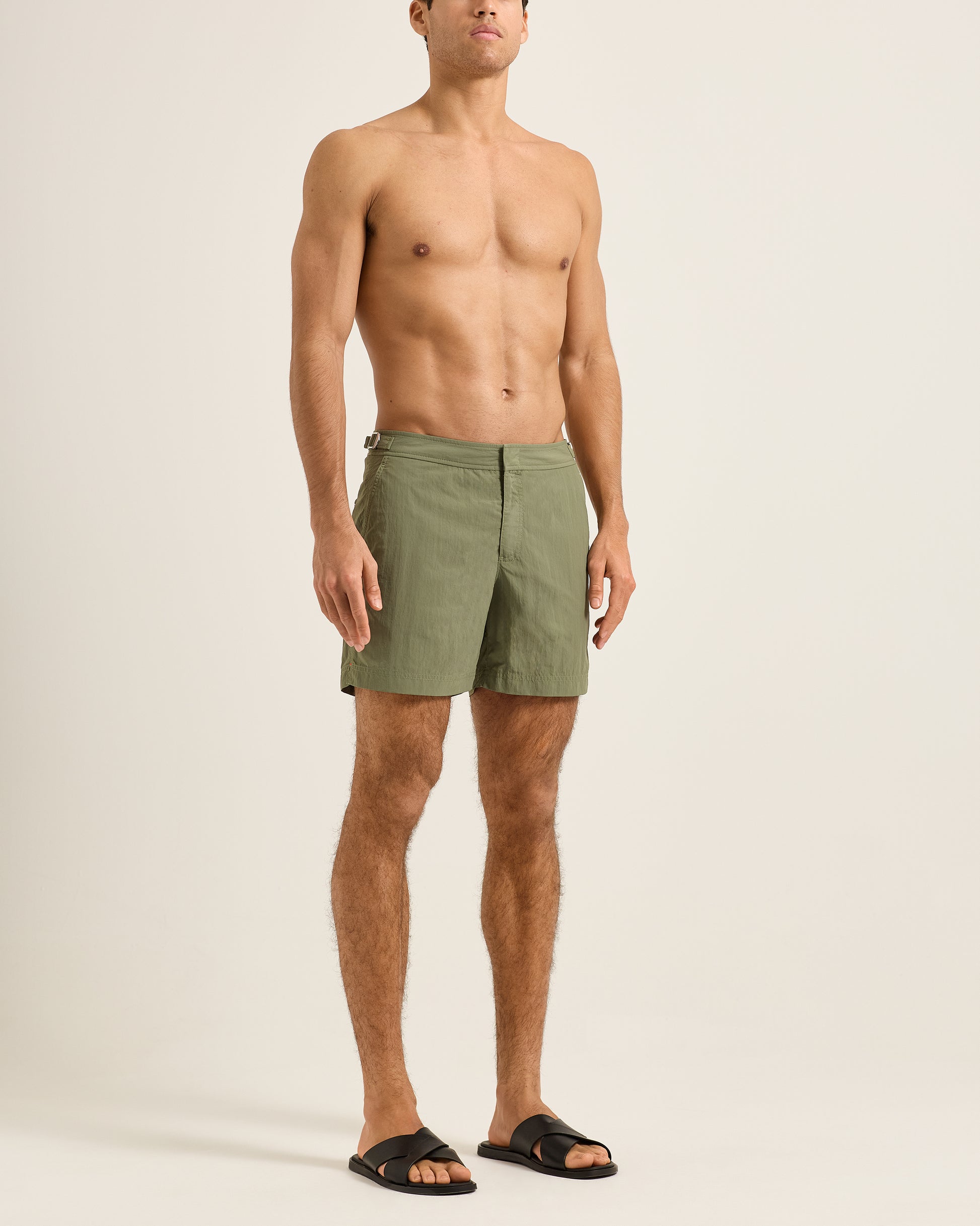 Man wearing green shorts on a plain background