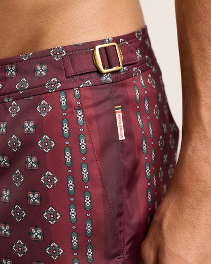 Maroon patterned shorts with a belt and visible brand label.