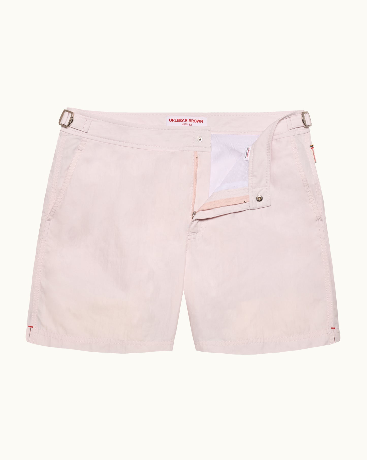 Light pink shorts with a brand label on a white background