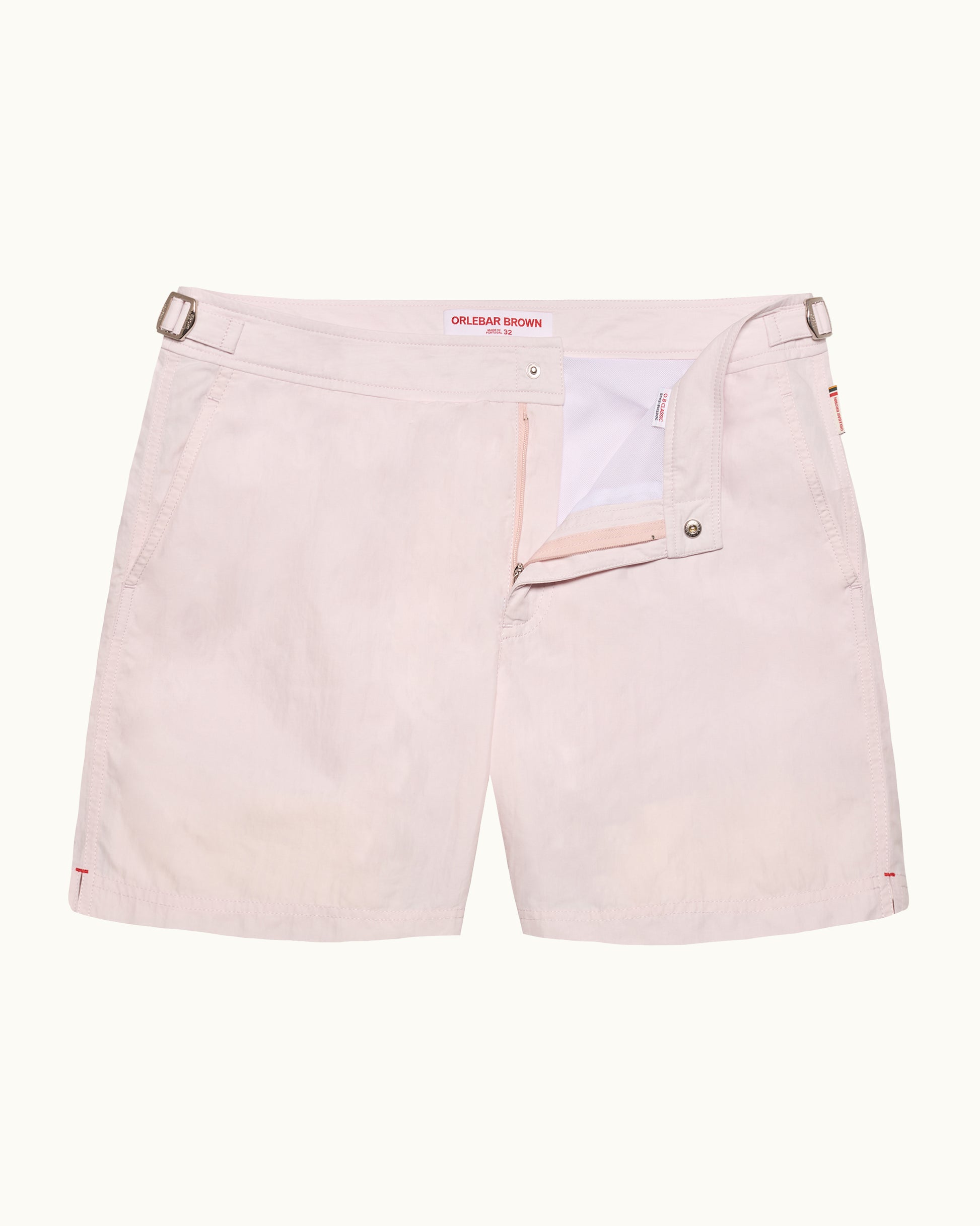 Light pink shorts with a brand label on a white background