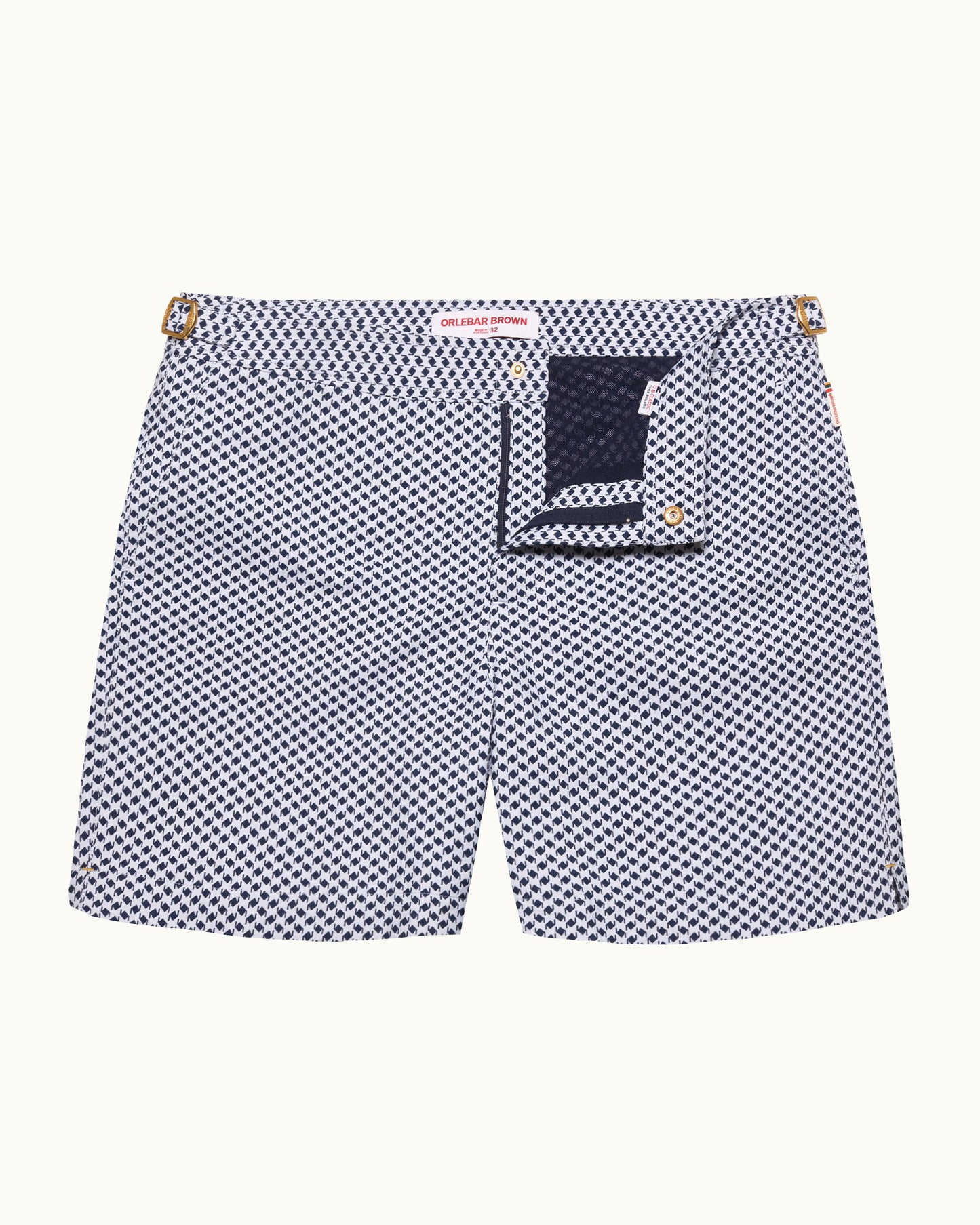 Navy and white checkered swim shorts with a brand label on a white background