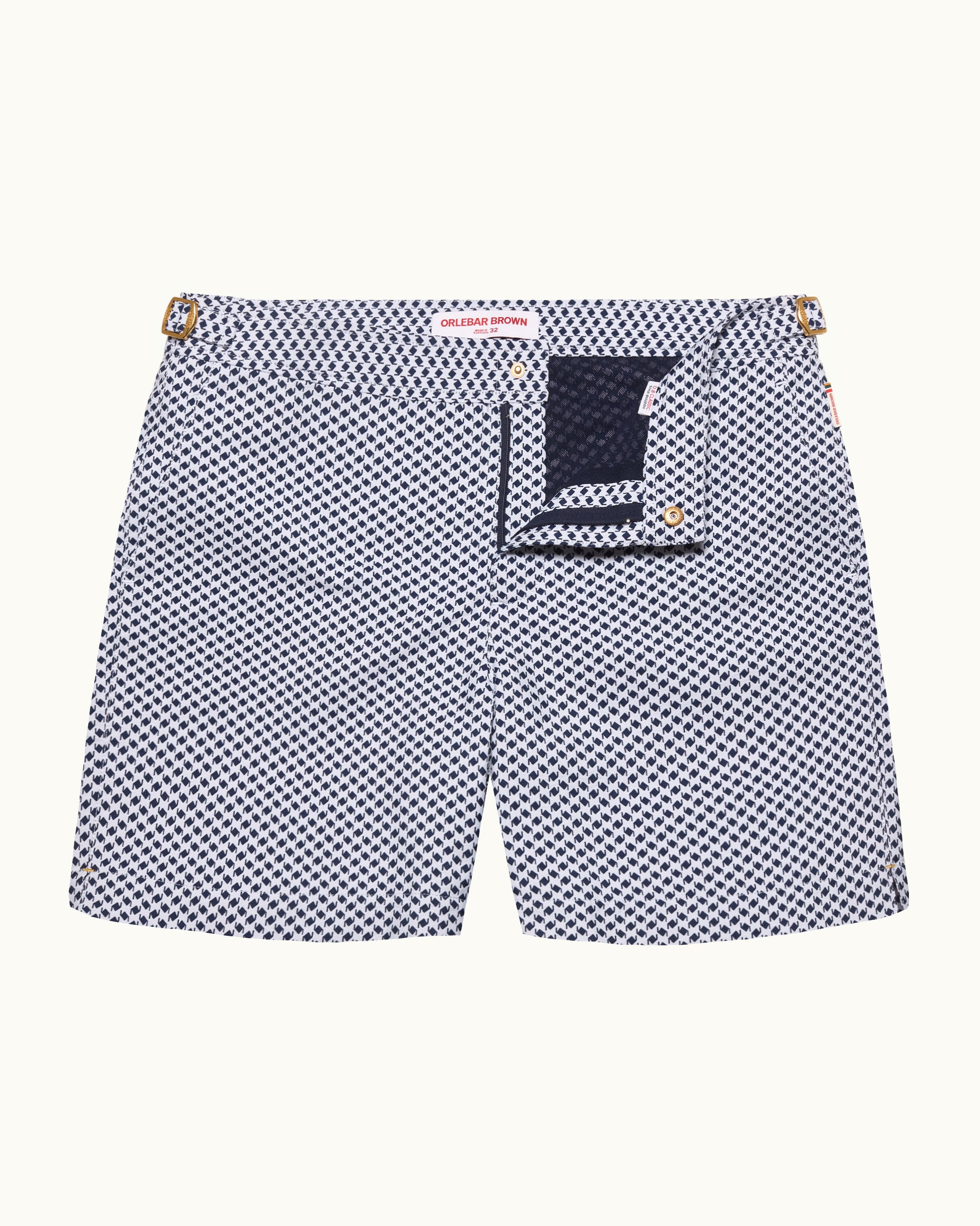 Navy and white checkered swim shorts with a brand label on a white background