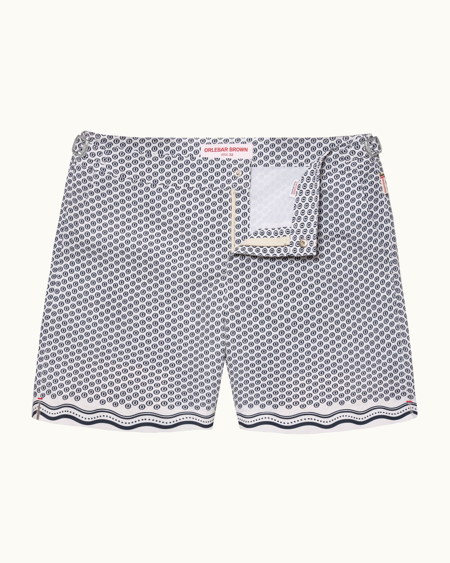A pair of men's swimshorts featuring a gray and white geometric pattern with a scalloped wavy hem and a matching fabric pocket detail on the front.