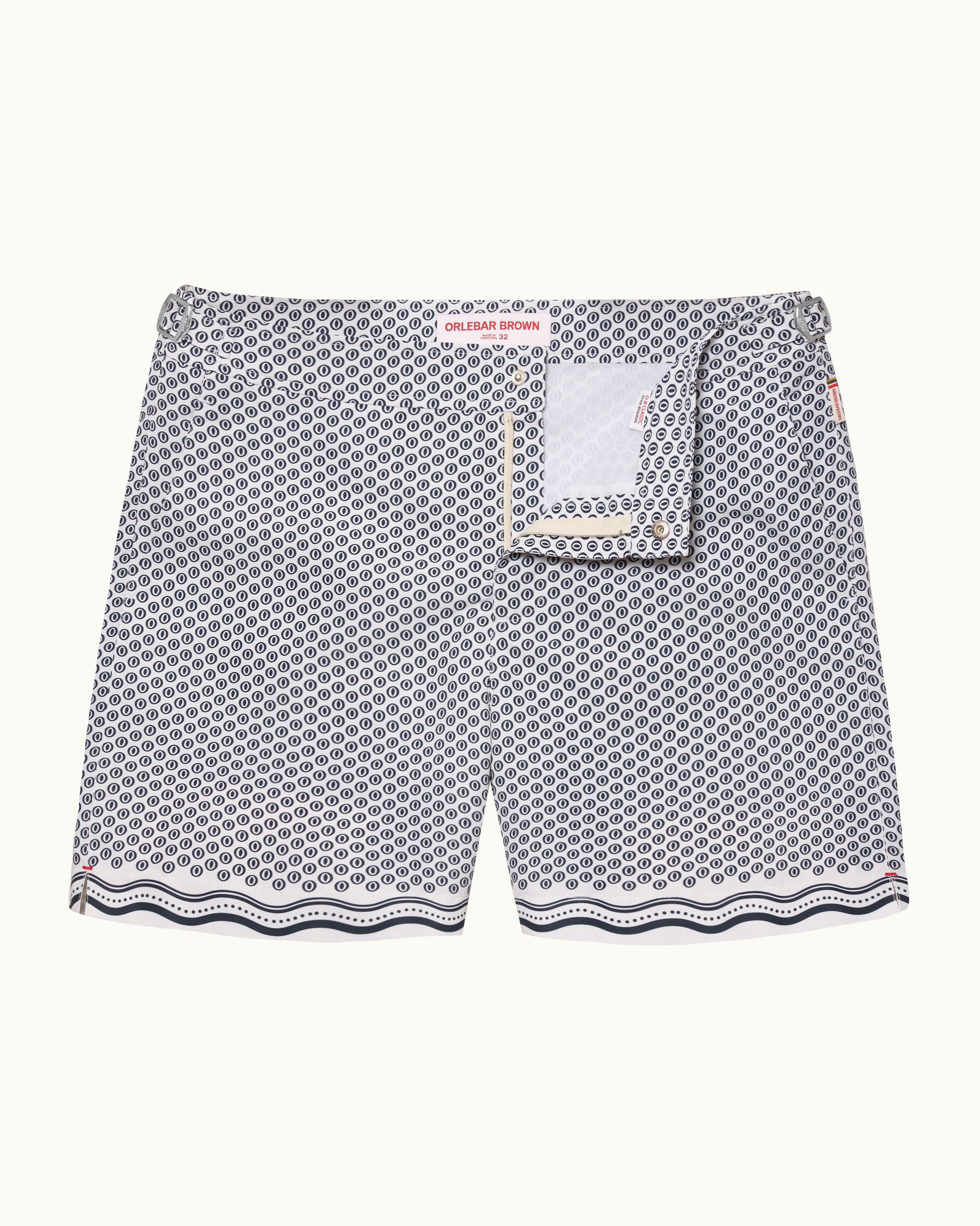 A pair of men's swimshorts featuring a gray and white geometric pattern with a scalloped wavy hem and a matching fabric pocket detail on the front.