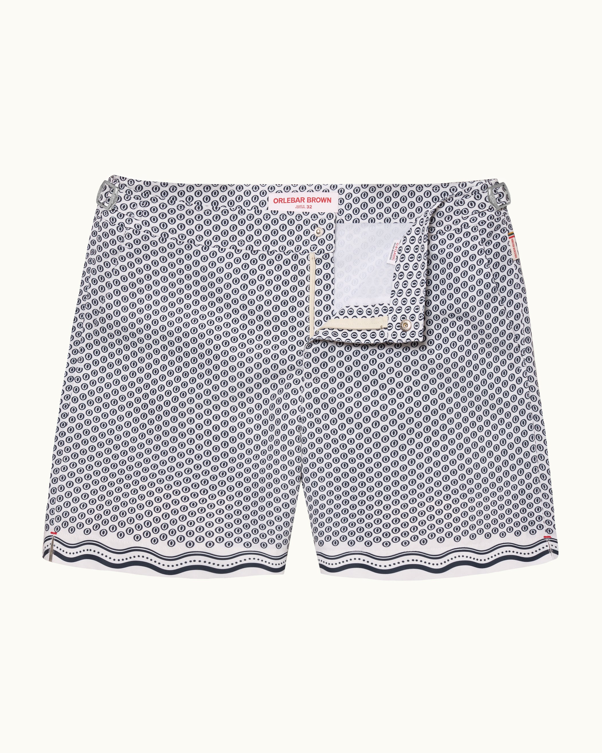 A pair of men's swimshorts featuring a gray and white geometric pattern with a scalloped wavy hem and a matching fabric pocket detail on the front.