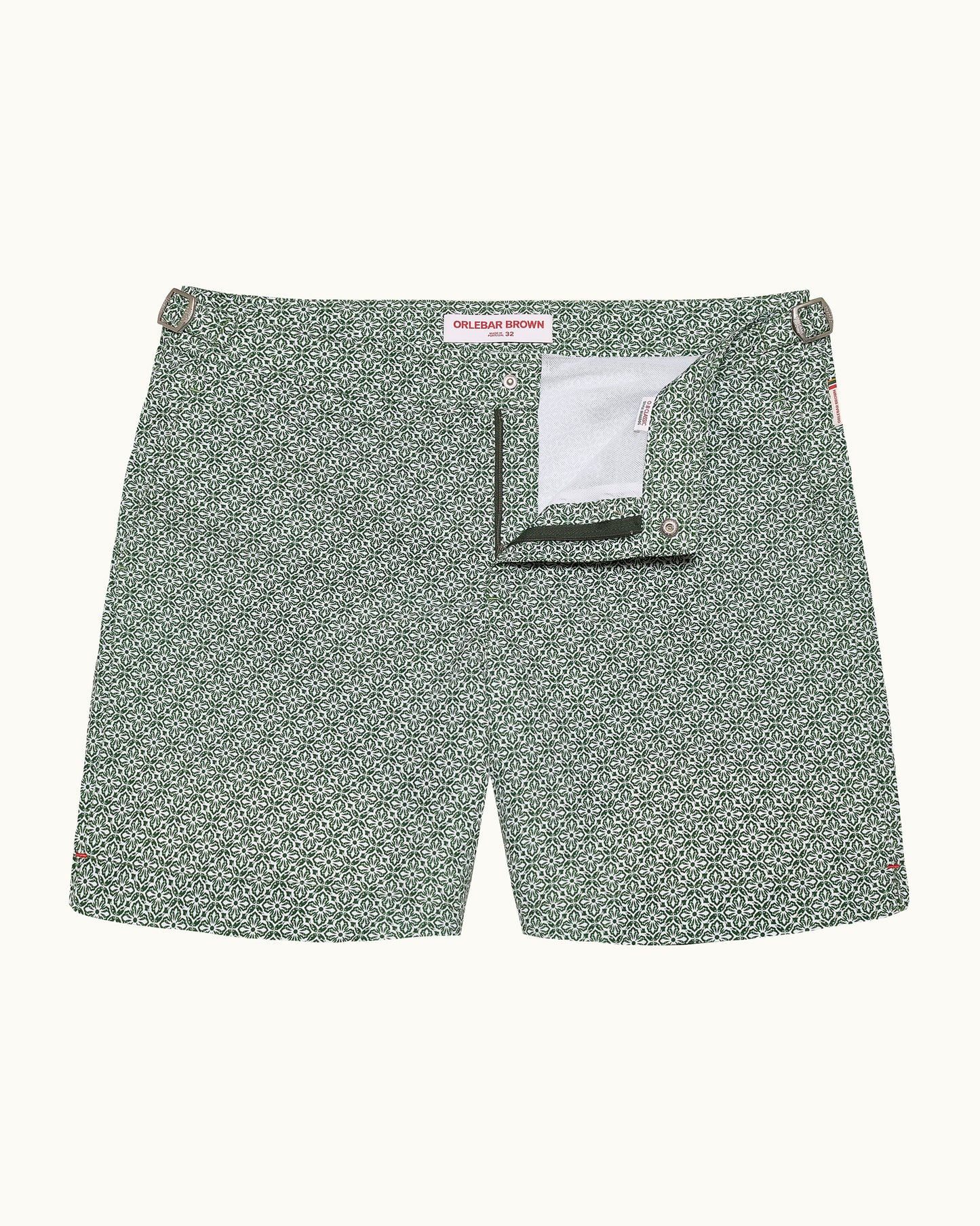 Green patterned shorts with a brand label on a white background