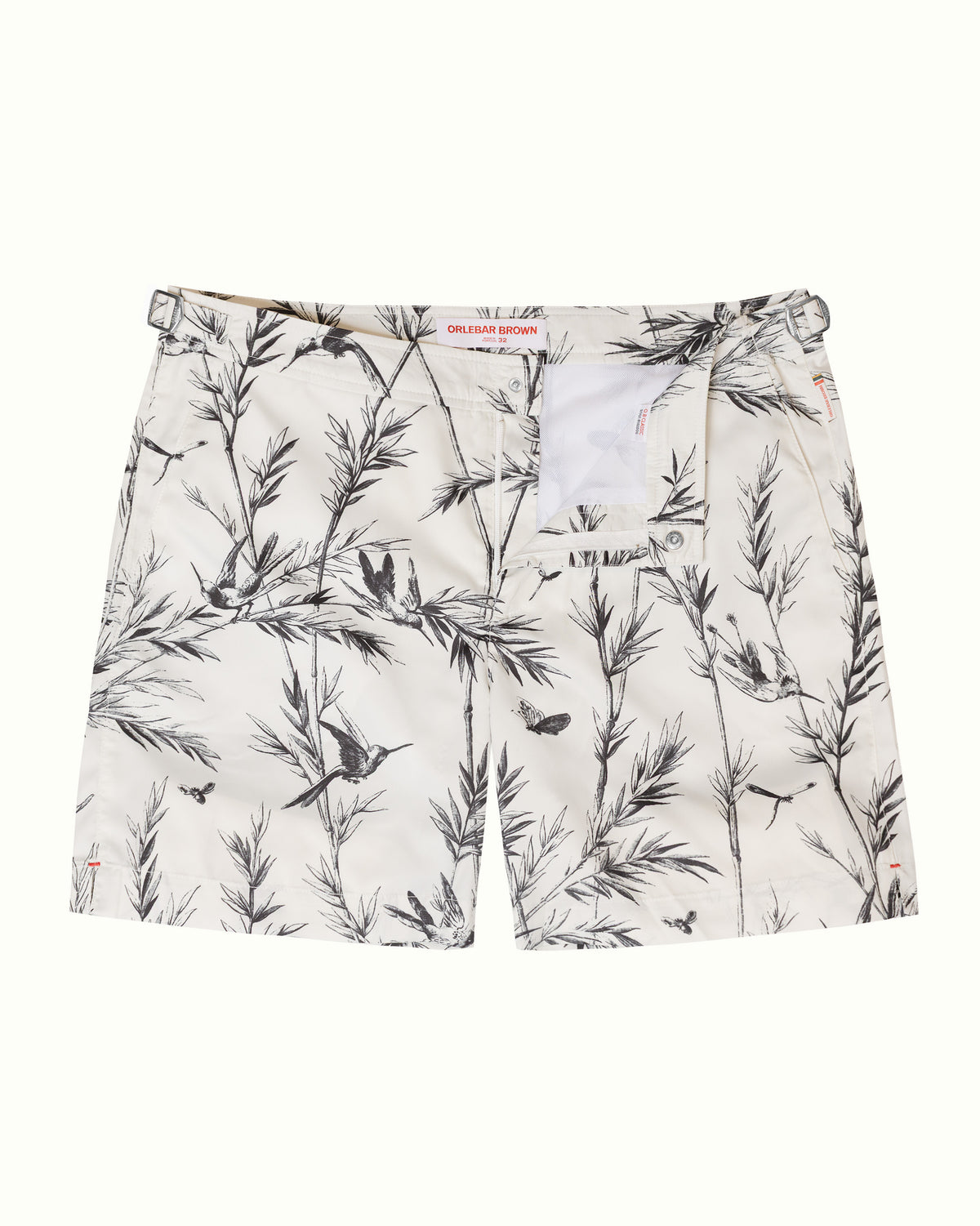 A pair of men's shorts featuring a black and white botanical print with birds and butterflies, laid flat against a light off-white background.