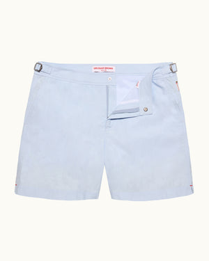 Light blue shorts with a brand logo on a white background