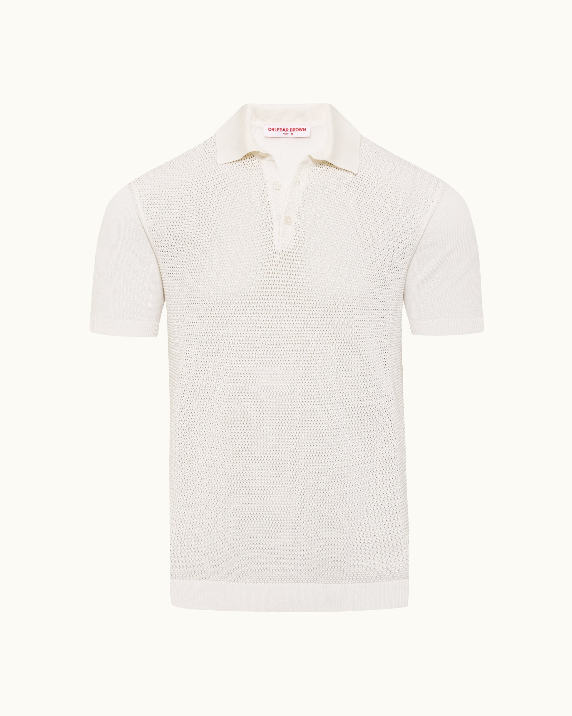 White polo shirt with textured knit on a plain background