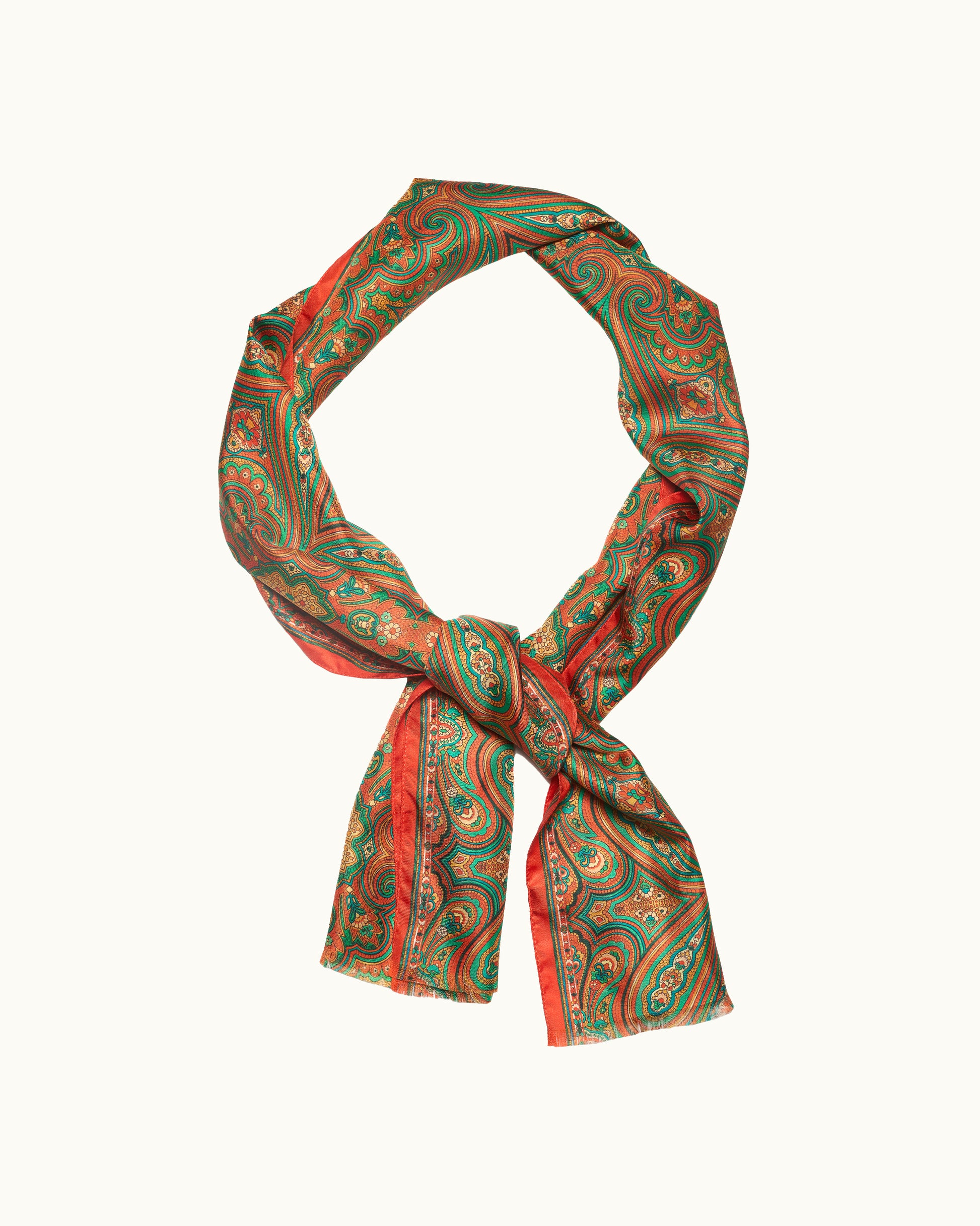 Green and red patterned scarf on a white background