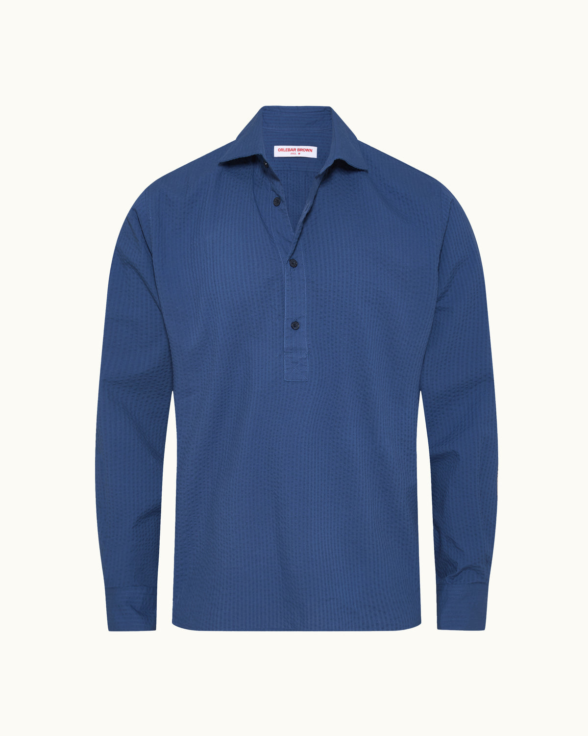 Dark blue long sleeve overhead shirt on a plain background