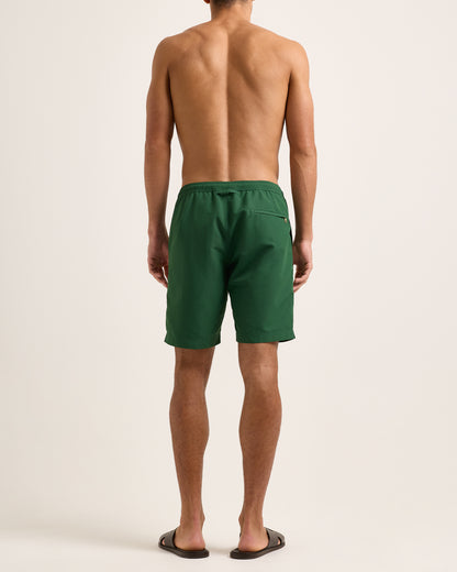 Man wearing green shorts with a drawstring on a white background