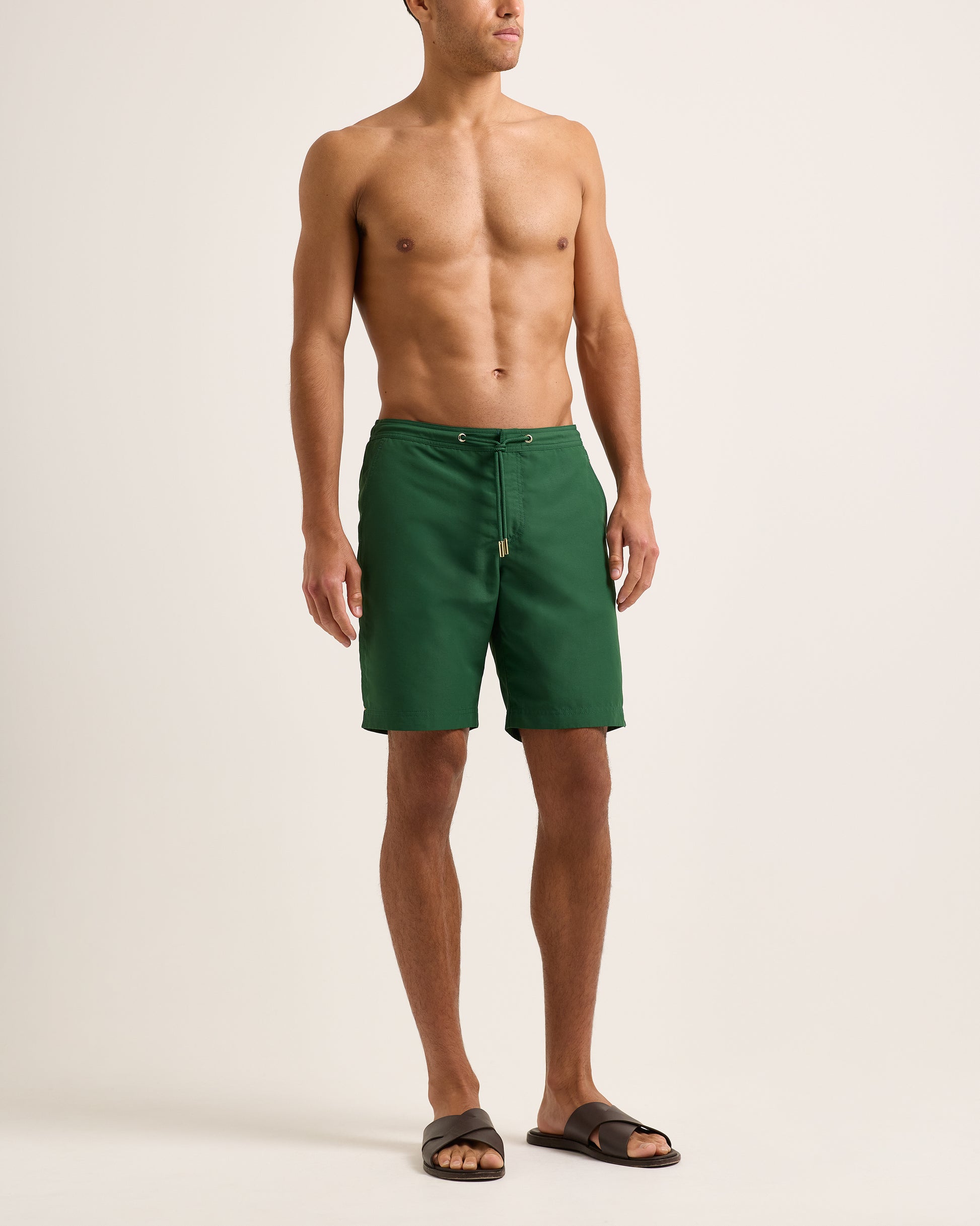 Man wearing green shorts with a drawstring on a white background