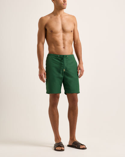 Man wearing green shorts with a drawstring on a white background
